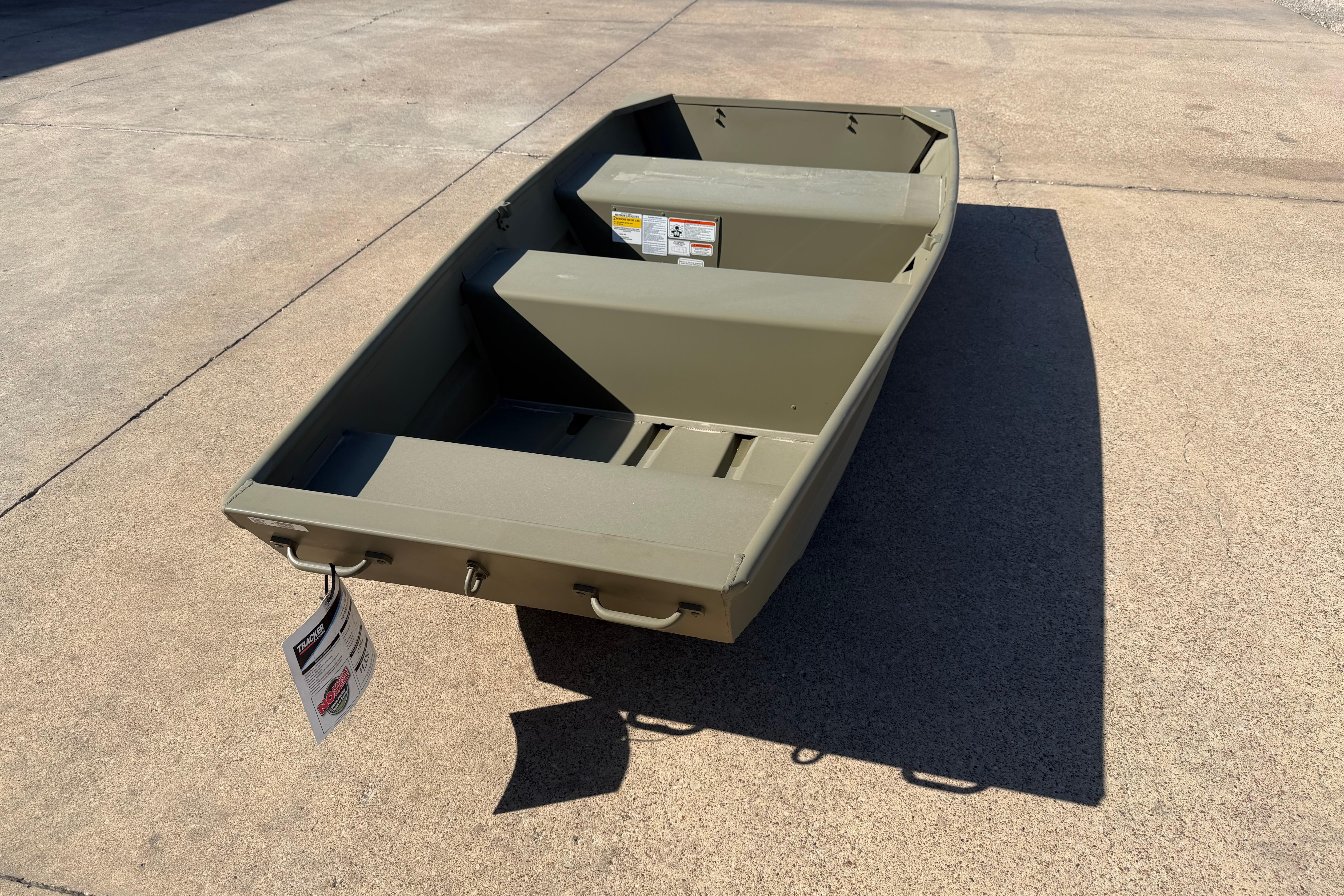 2026 Tracker Grizzly 10 Jon boat on concrete surface, showcasing its compact design.