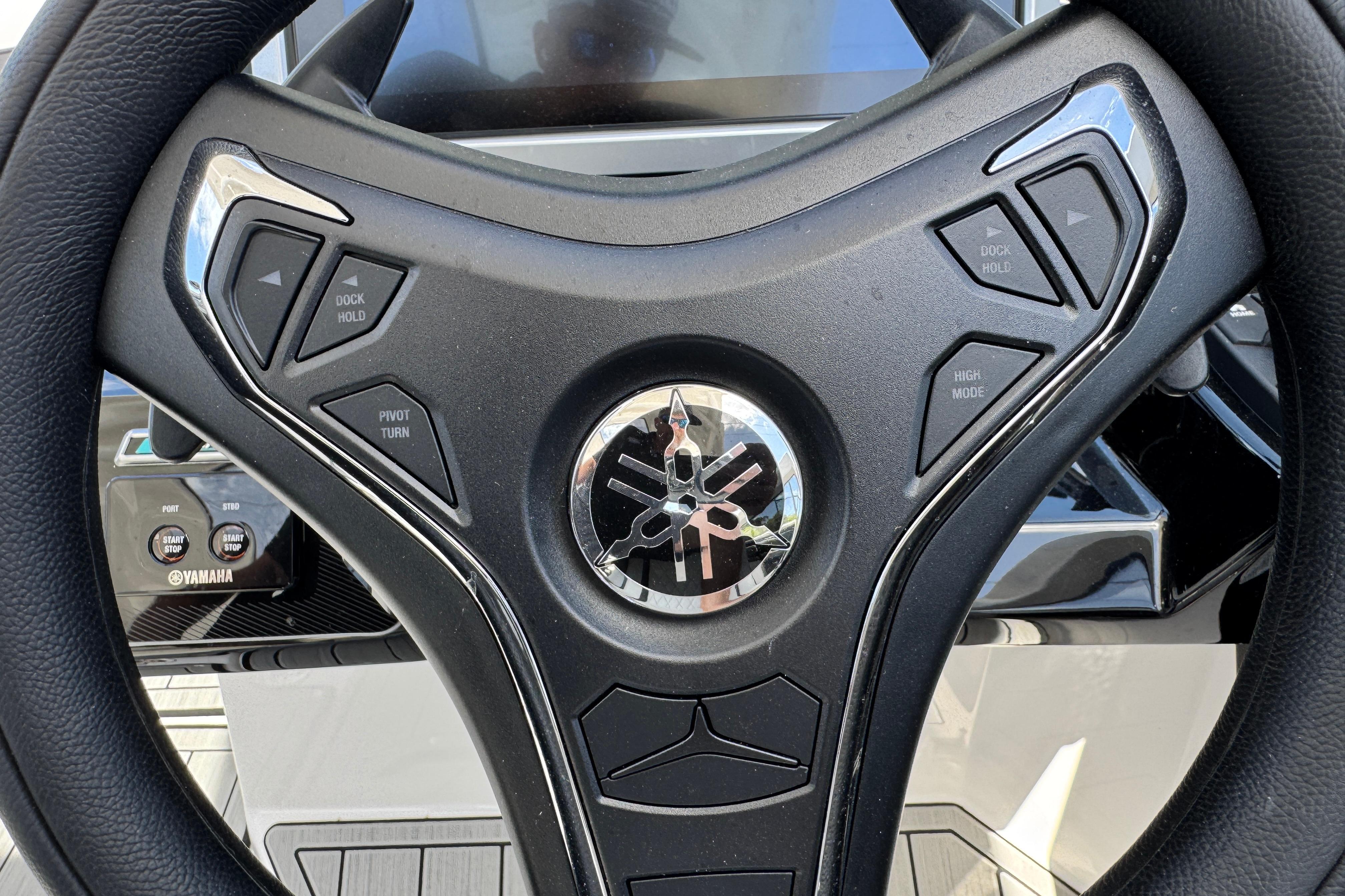 Steering wheel of 2026 Yamaha Boats 275SD with control buttons and logo.
