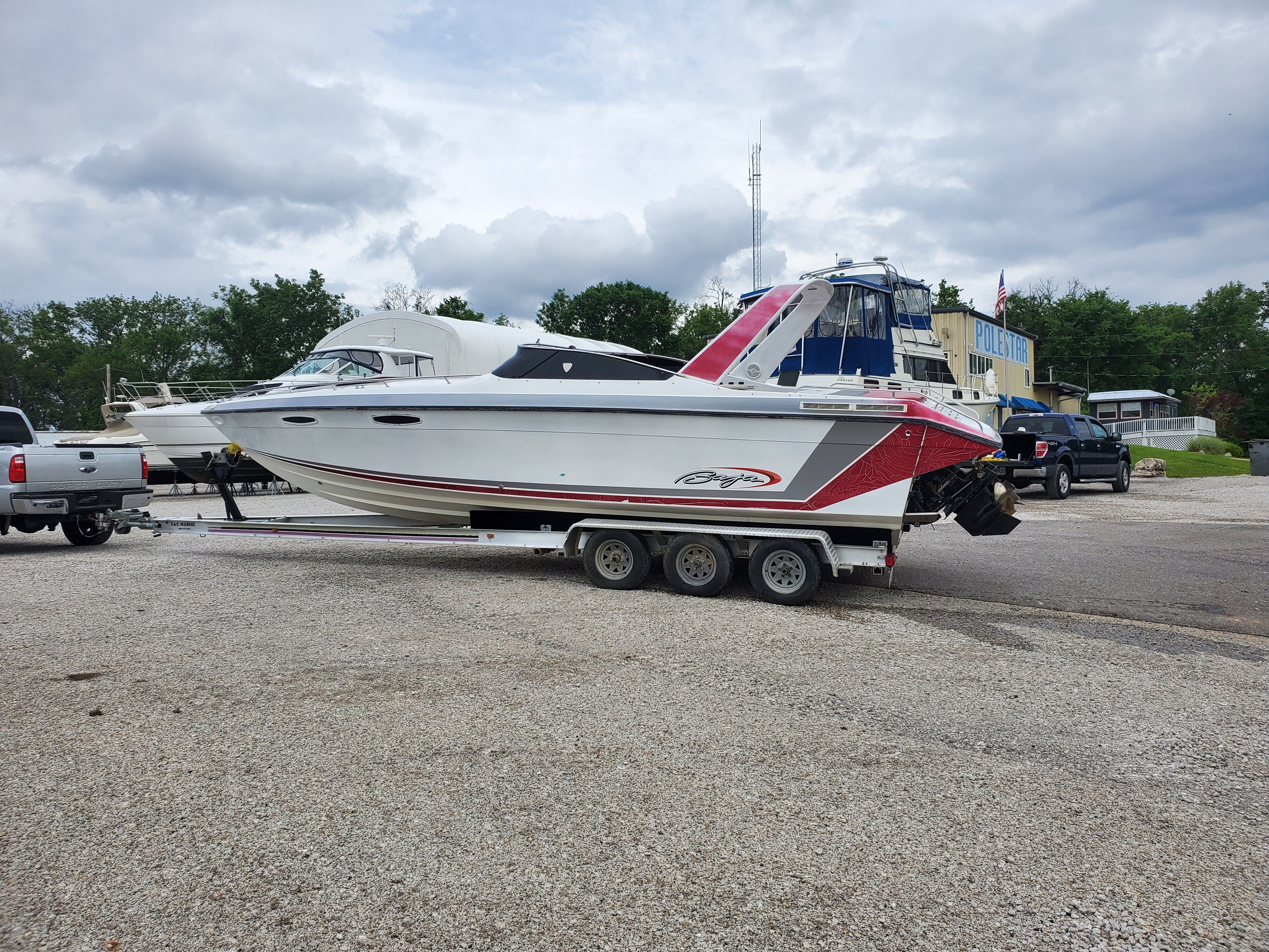 1989 Baja 280 Sport boat on trailer outdoors.