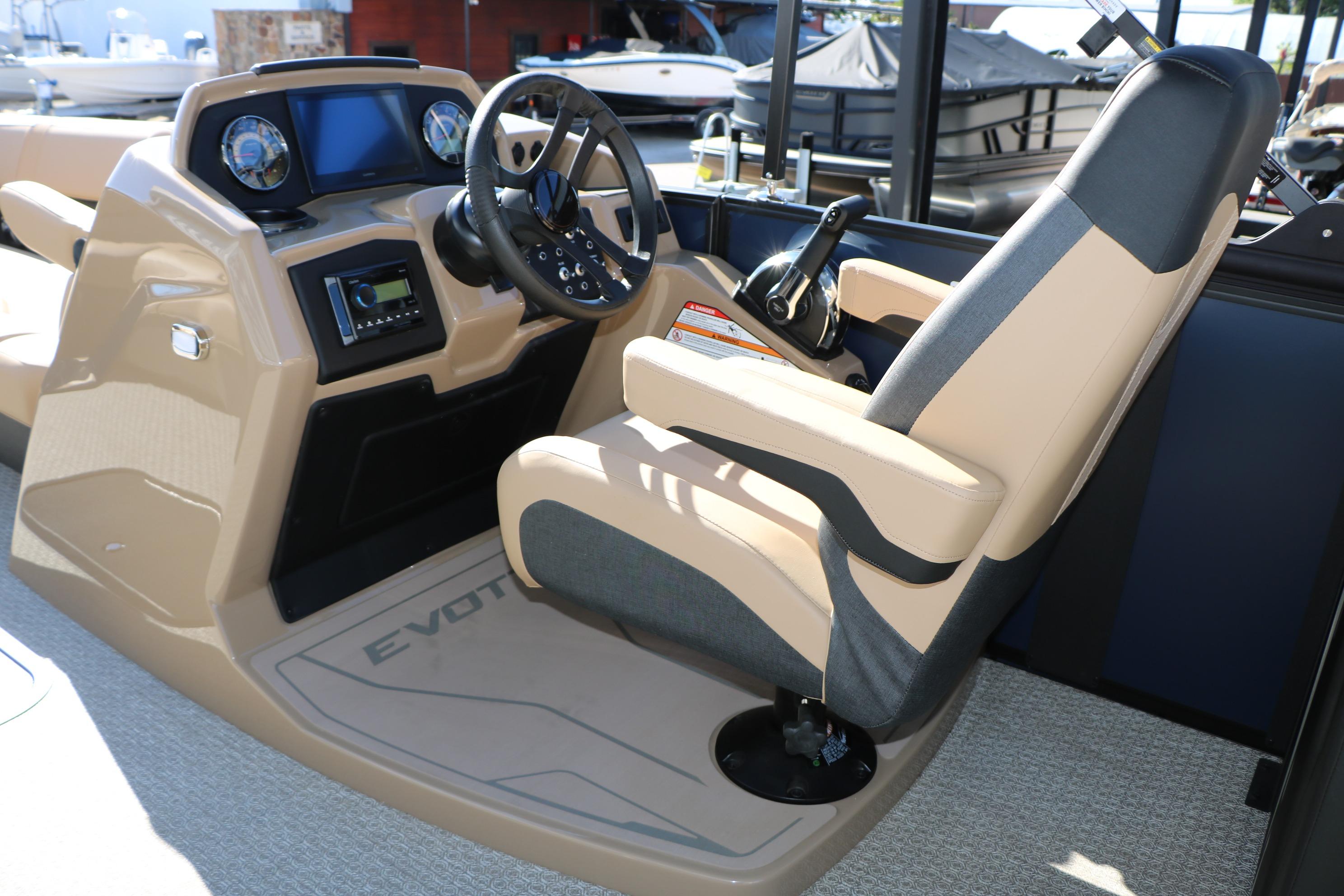 Captain's seat and dashboard of 2026 Evotti 525 QL Tri-Toon boat.