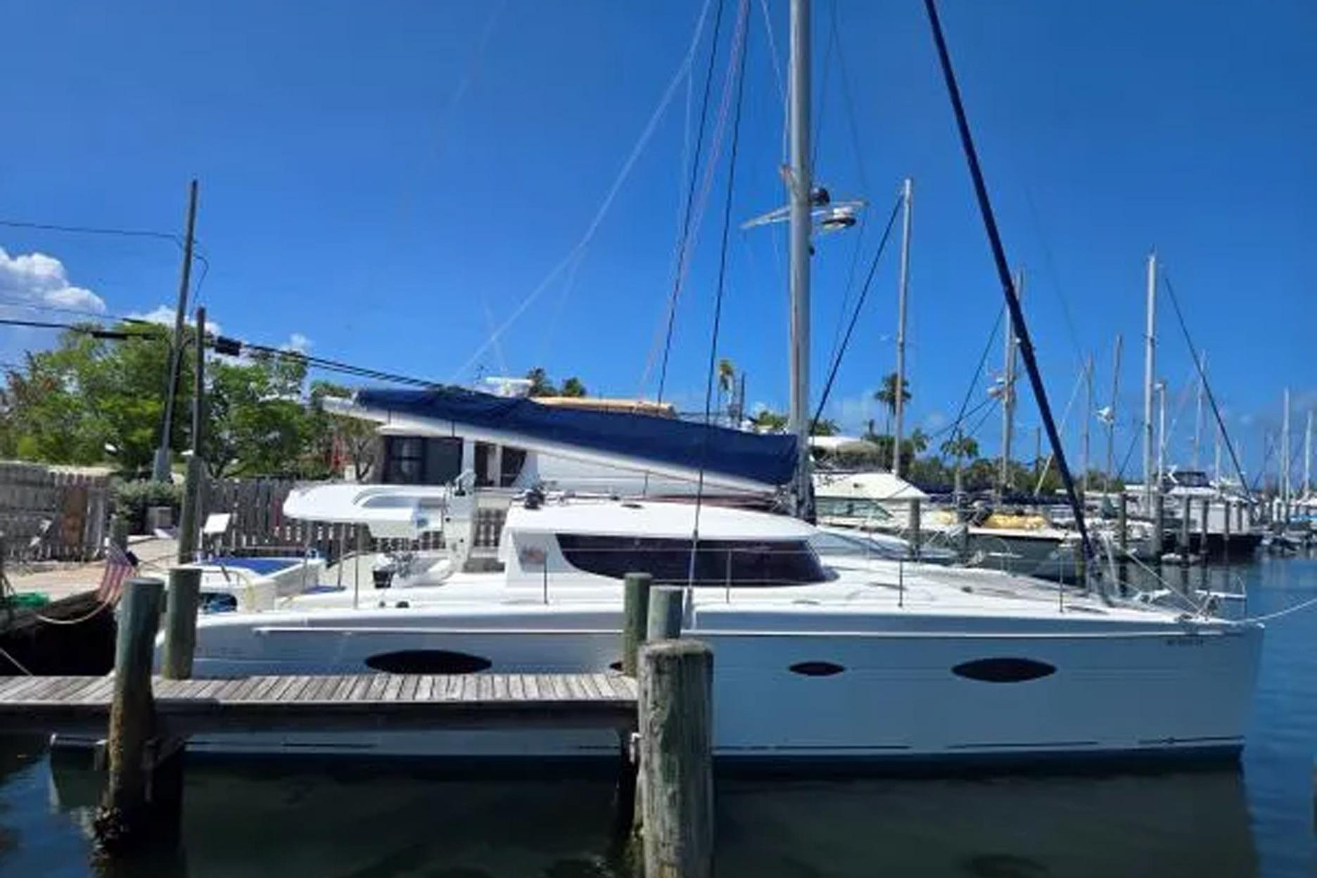 2008 Fountaine Pajot Salina 48 catamaran docked at marina under clear blue sky.