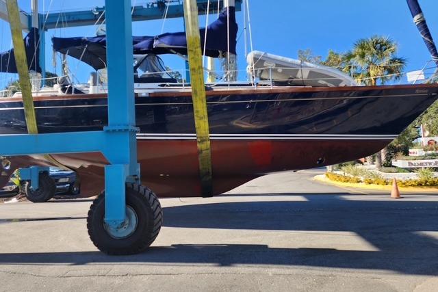 1984 Bristol 45.5 Center Cockpit sailboat in dry dock, blue hull, sunny day.