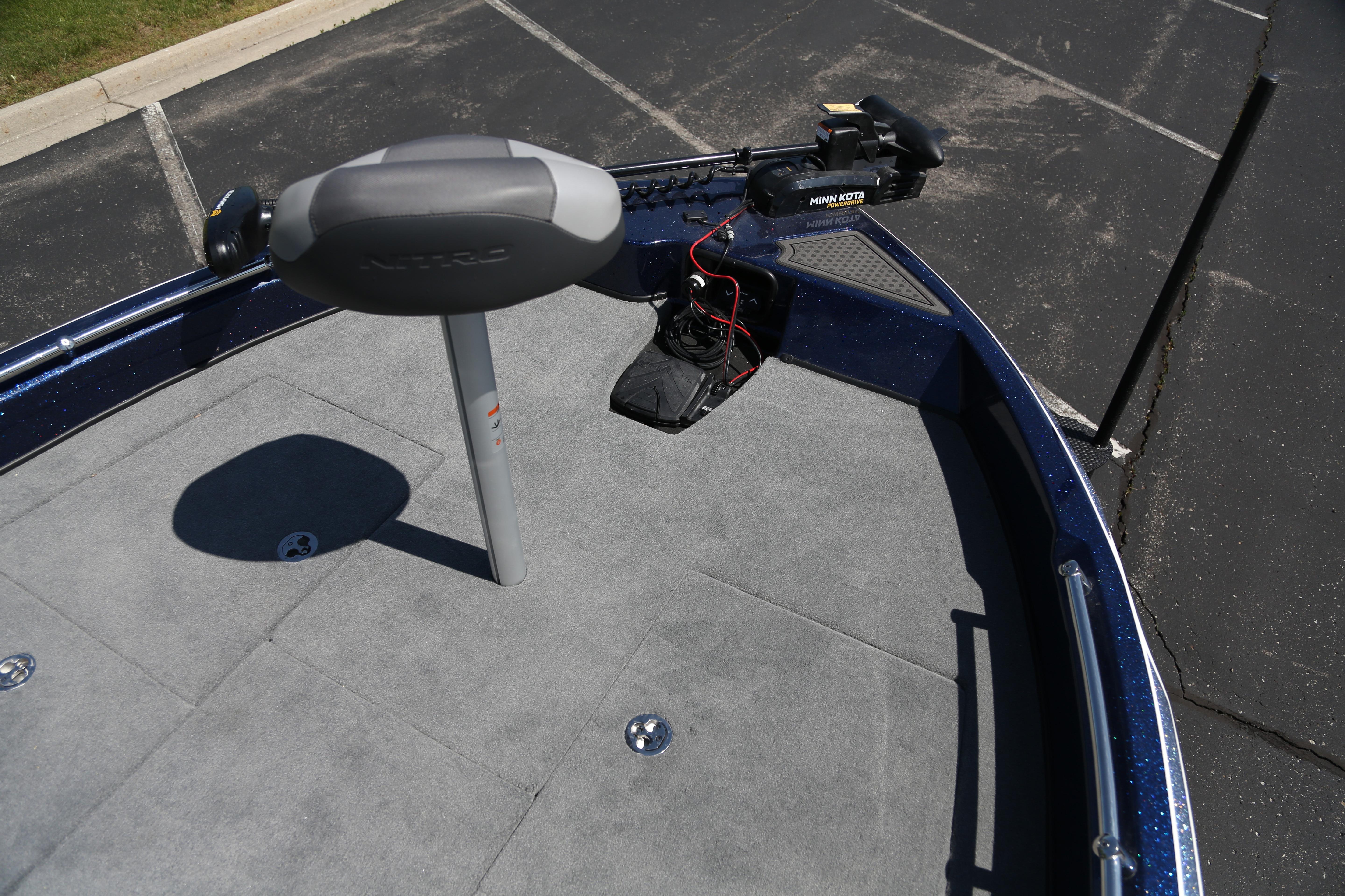 2026 Nitro ZV19 boat deck with Minn Kota trolling motor, parked on asphalt.
