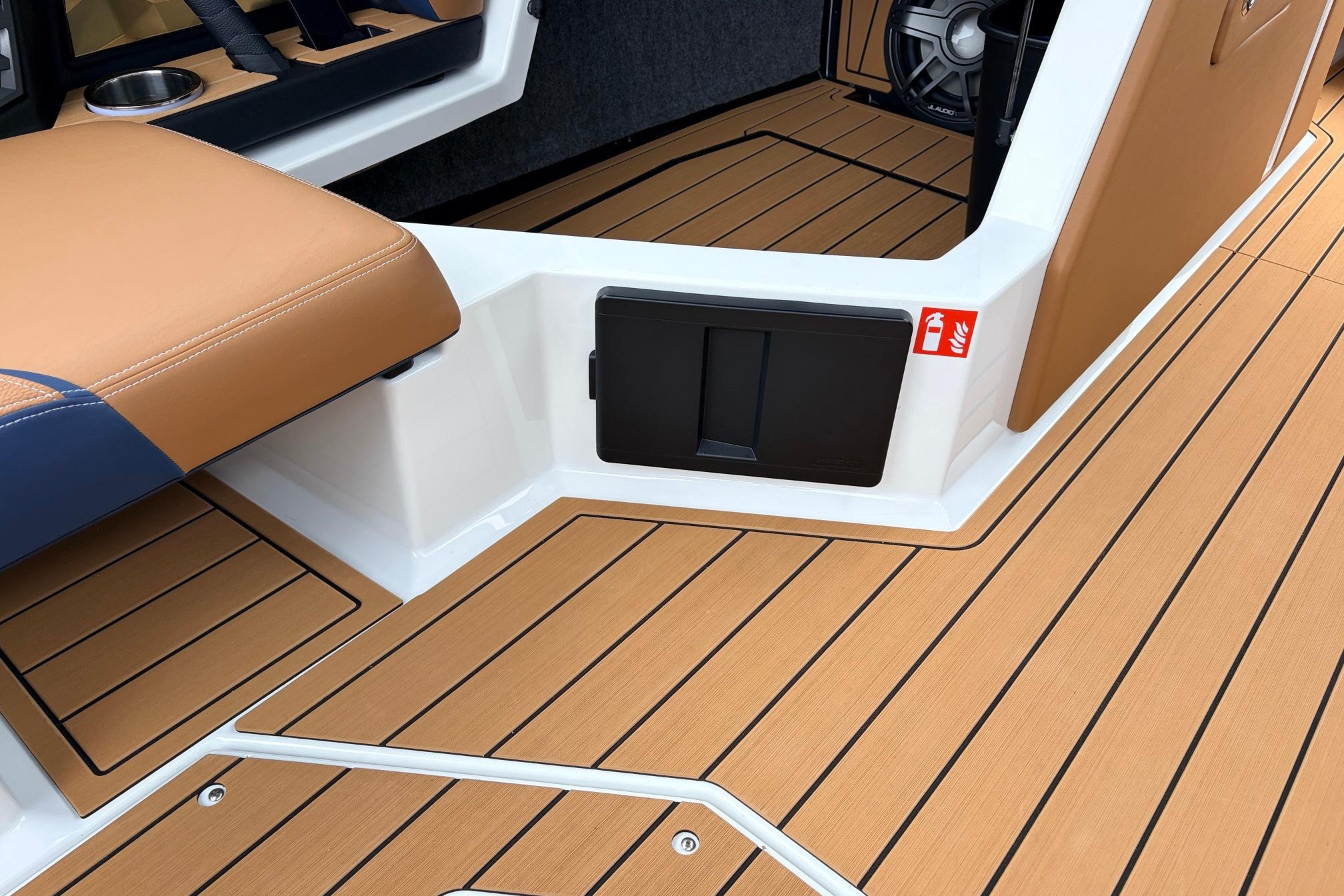 2026 Nautique Super Air Nautique G25 interior with tan seating and teak flooring.