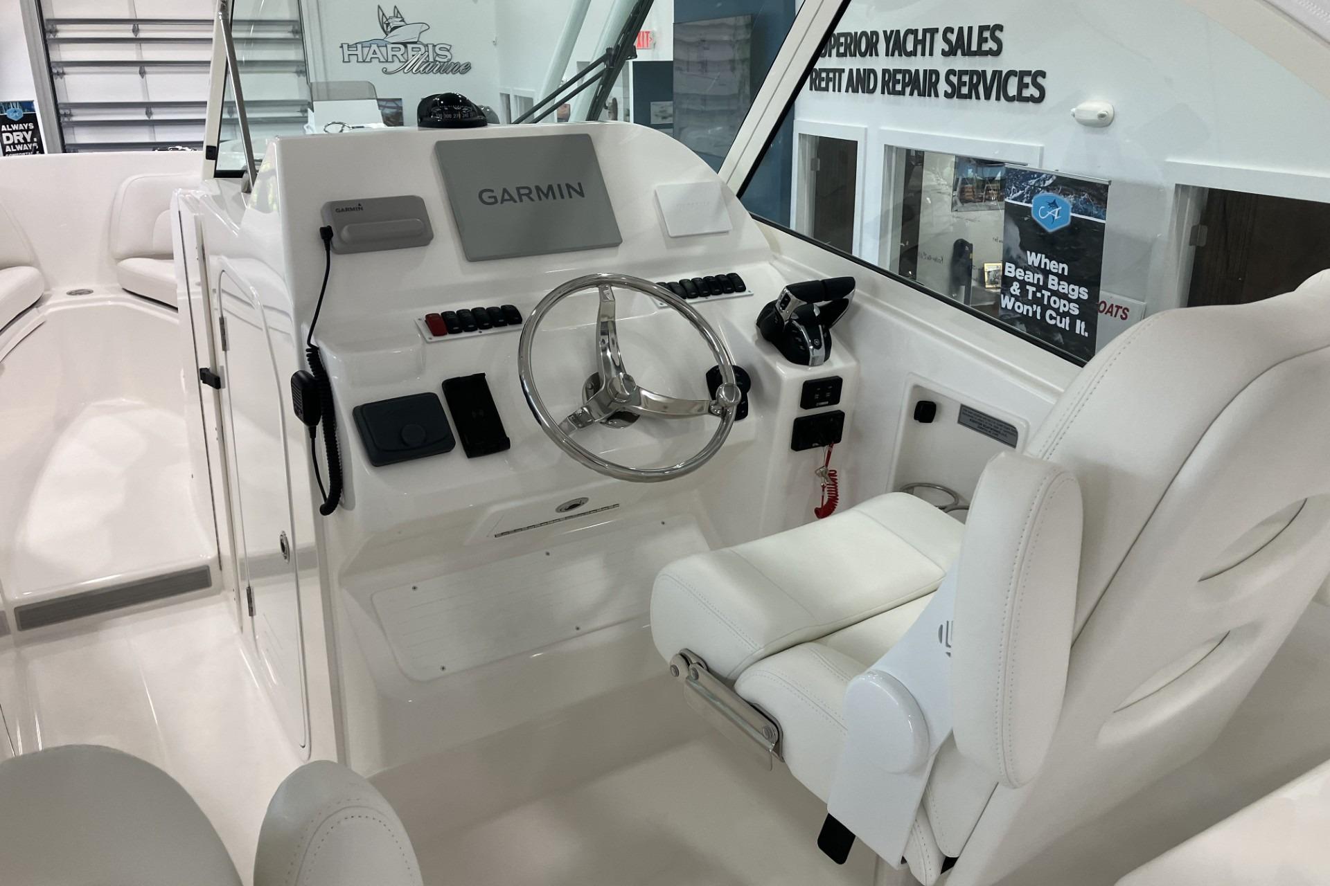 2026 Albemarle 27 Dual Console boat interior with Garmin navigation system and white seating.