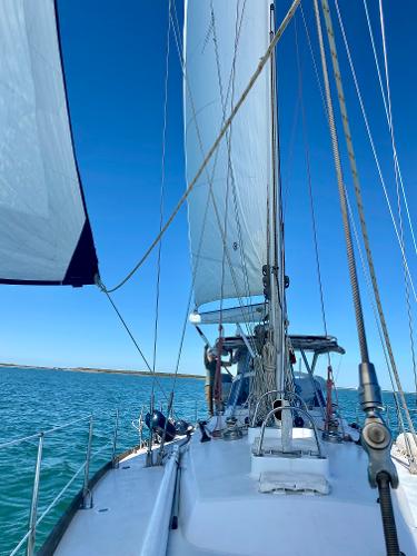 Sailing on a 1989 Concordia 52 yacht with full sails on a clear day.