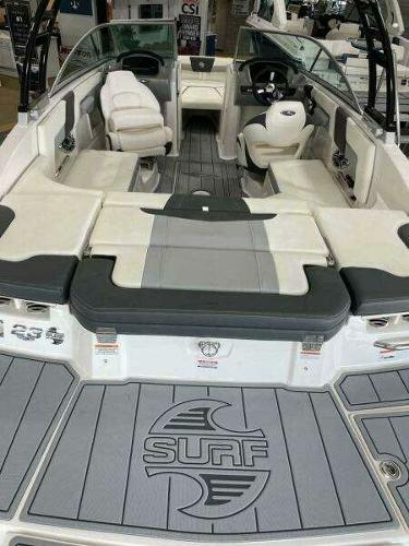 2022 Chaparral 23 Surf boat interior with seating and steering wheel.