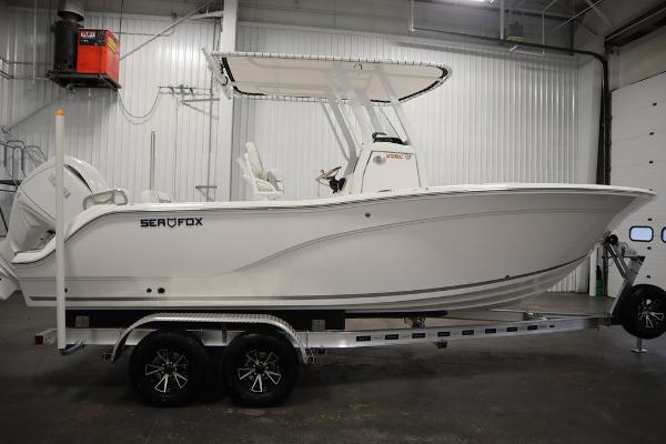 2025 Sea Fox 228 Commander boat on trailer in indoor storage.