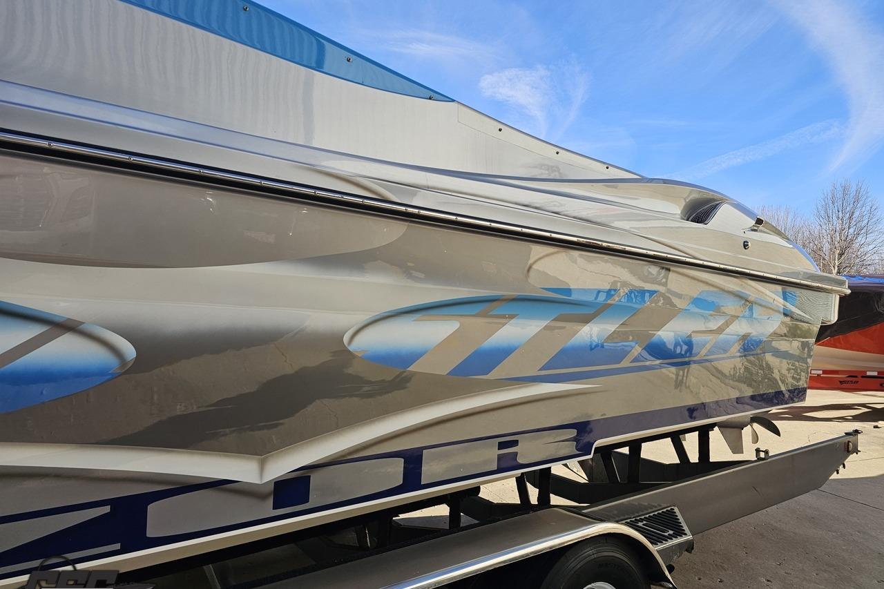 2007 Hustler 41 Razor boat with sleek design and vibrant graphics on trailer.