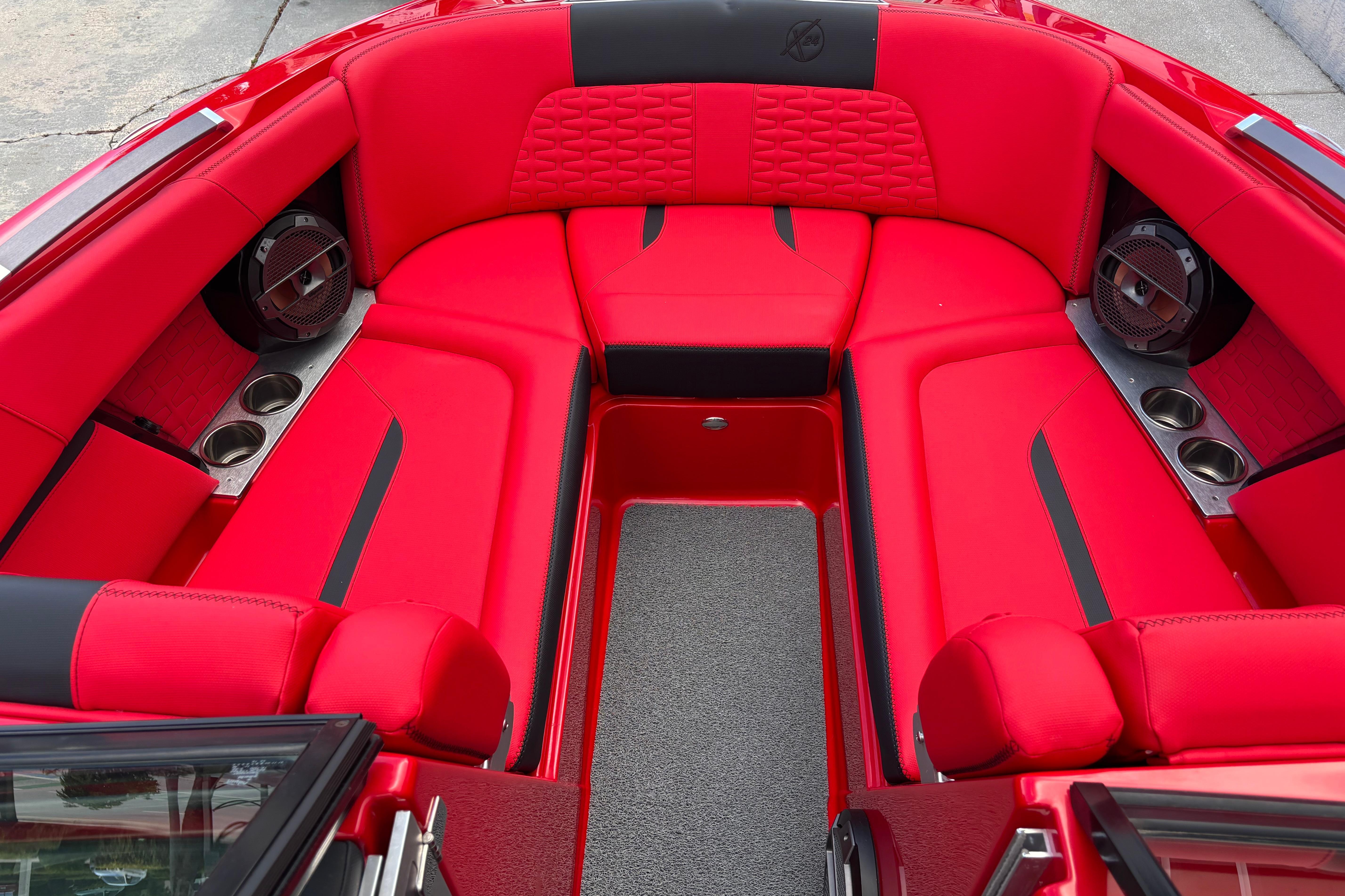 2020 MasterCraft X24 boat interior with vibrant red seating and cup holders.