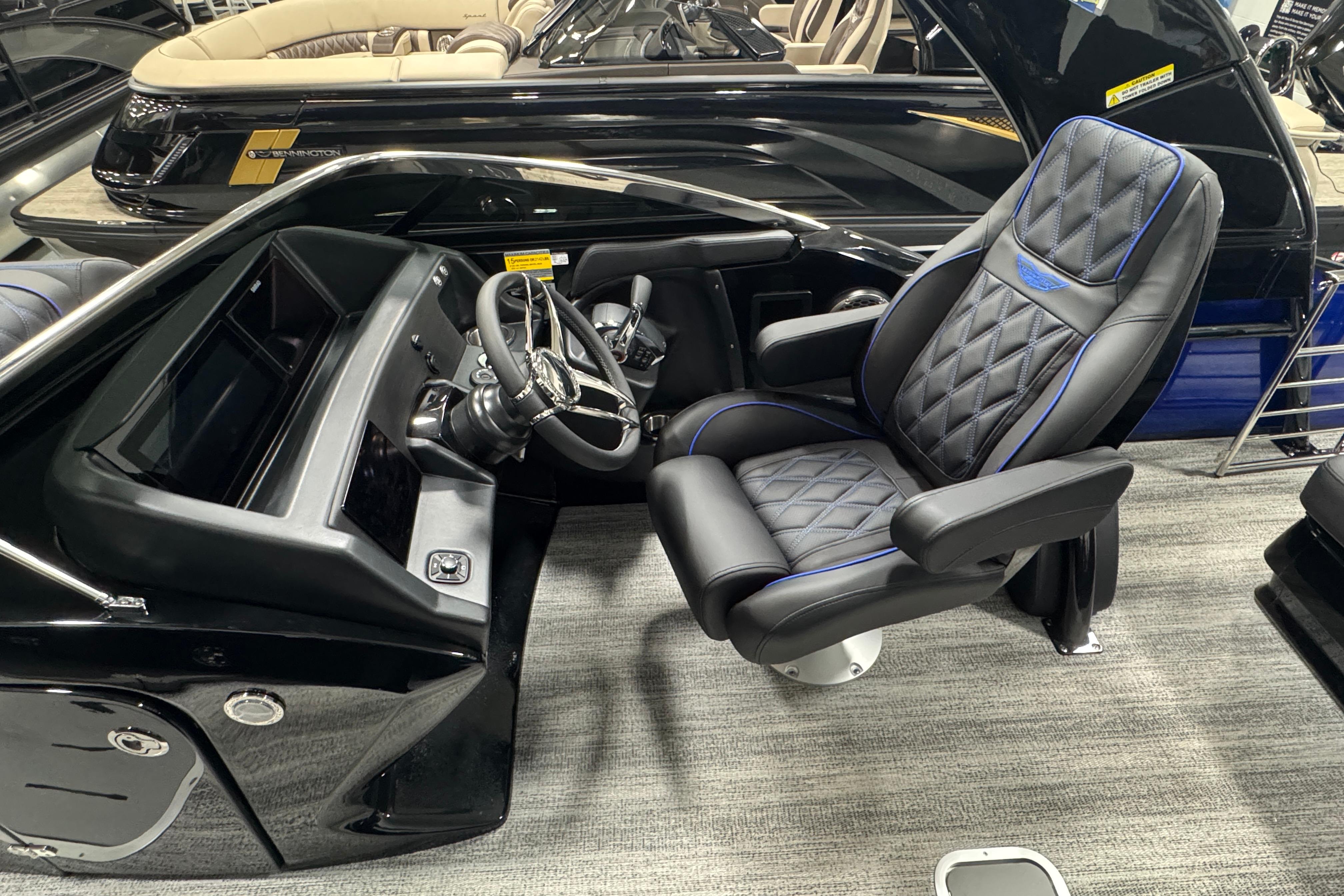 Luxurious helm of 2026 Bennington 25 QSBWASE pontoon boat with plush captain's chair.