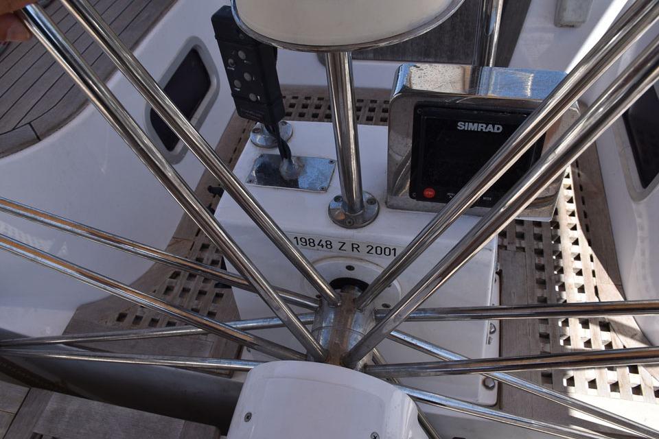Steering wheel and controls of a 2001 Farr 65 yacht with Simrad equipment.