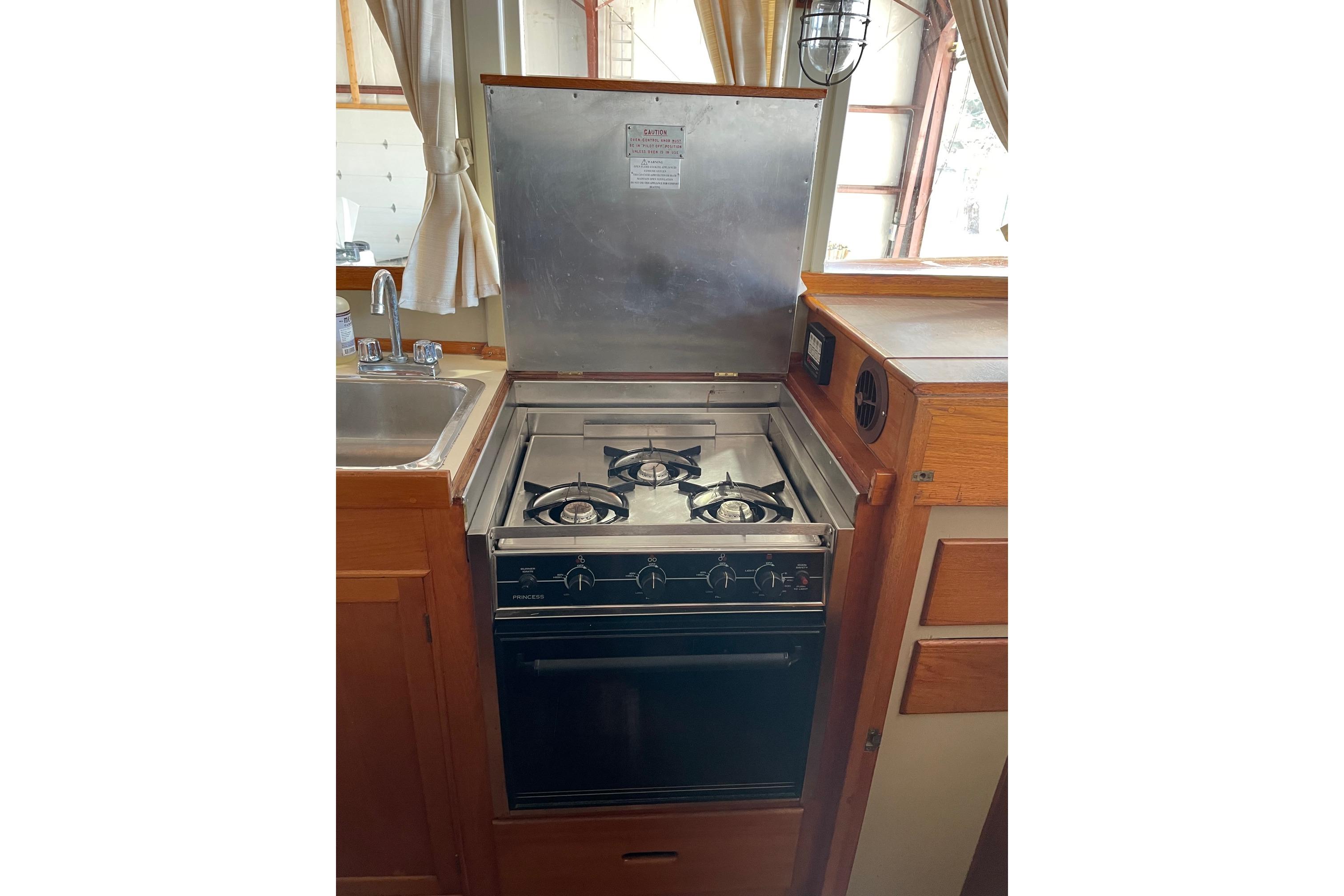 1978 Grand Banks GB36570 boat kitchen with stove, oven, and sink.