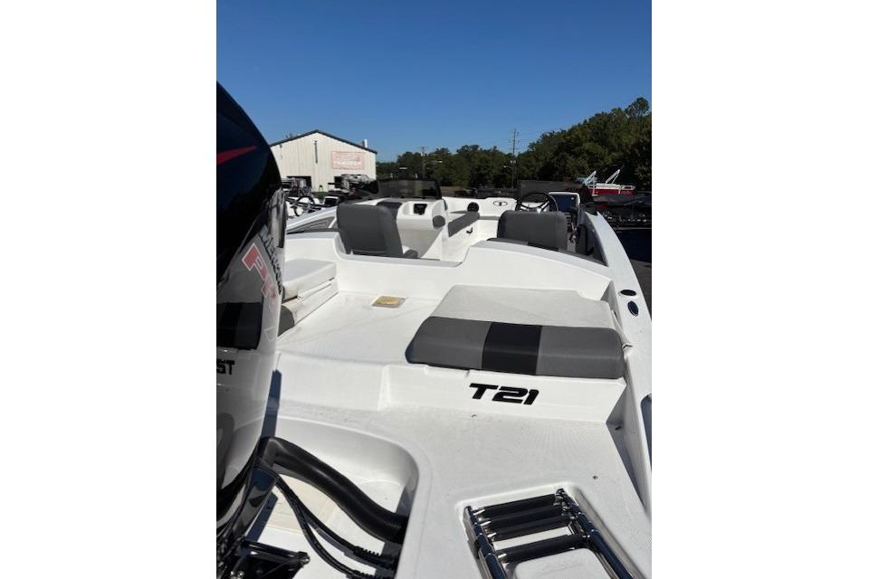 2025 Tahoe T21 boat with seating and motor, displayed outdoors.