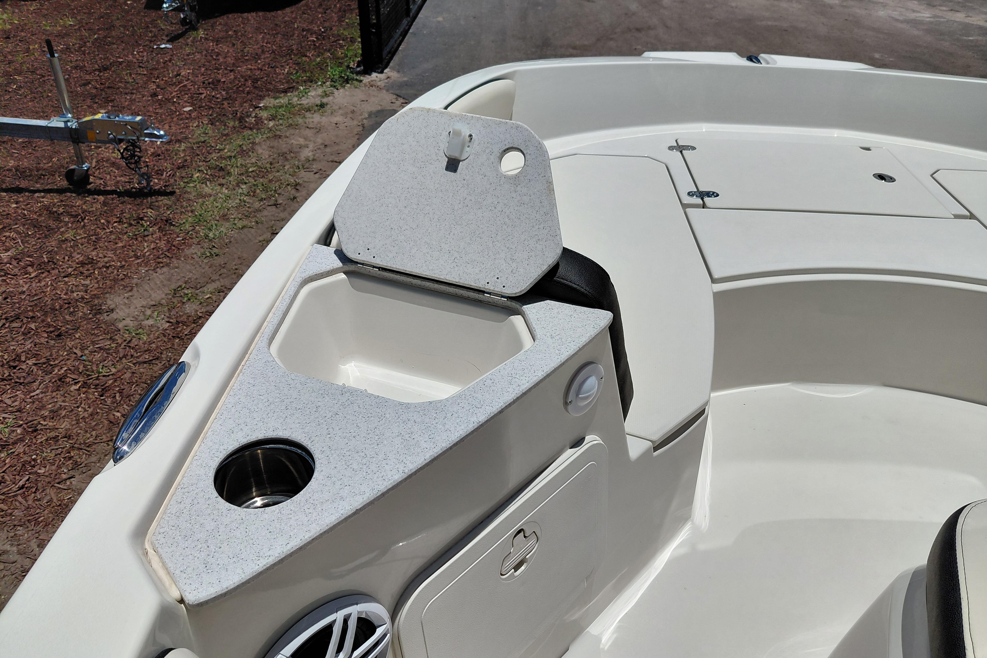 2023 Stingray 206 CC boat interior with storage compartment and cup holder.