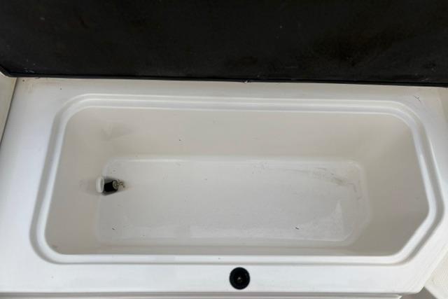 Storage compartment of a 2017 Searay SPX210 boat, featuring a clean, white interior.