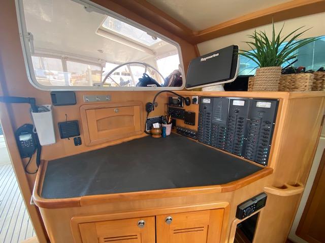 Navigation station of 2003 Perry Passagemaker 43 with control panels and decor.
