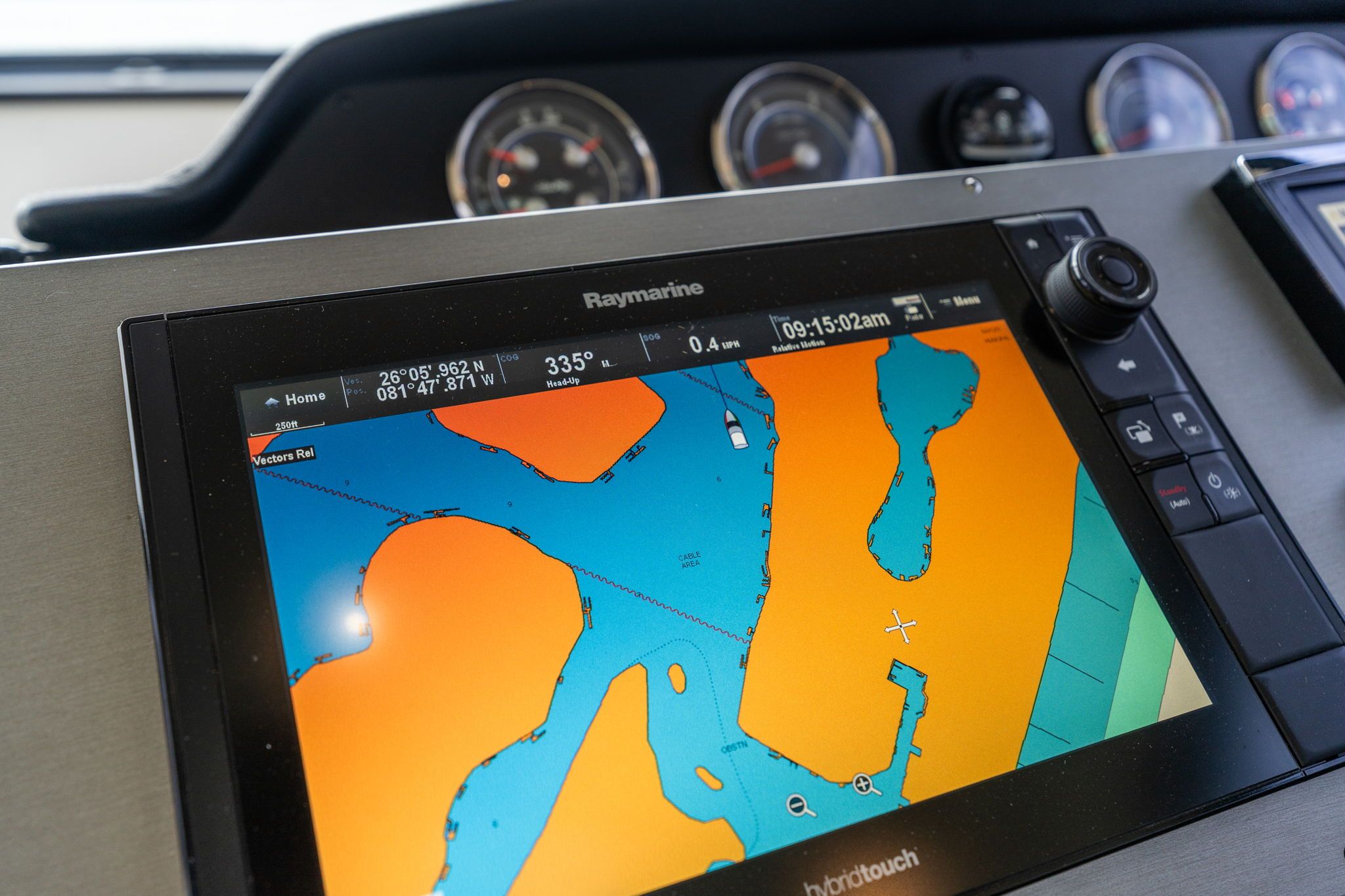 The image shows a boat's navigation system with a digital nautical chart.