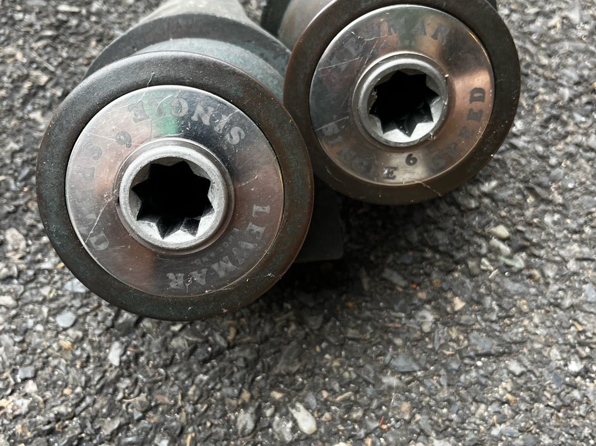 Close-up of two metal parts with star-shaped openings.