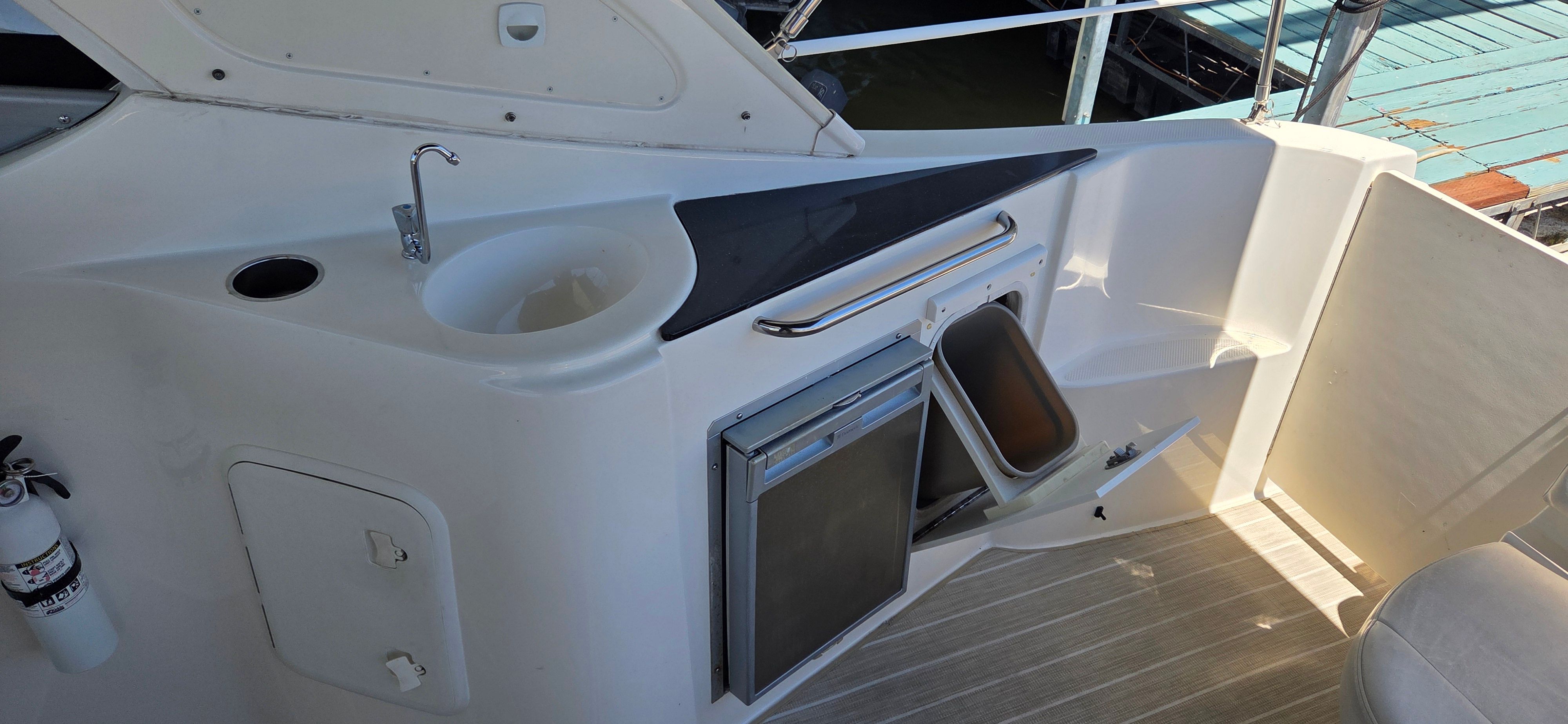 Interior of 2012 Bayliner 335 Cruiser with sink and refrigerator.