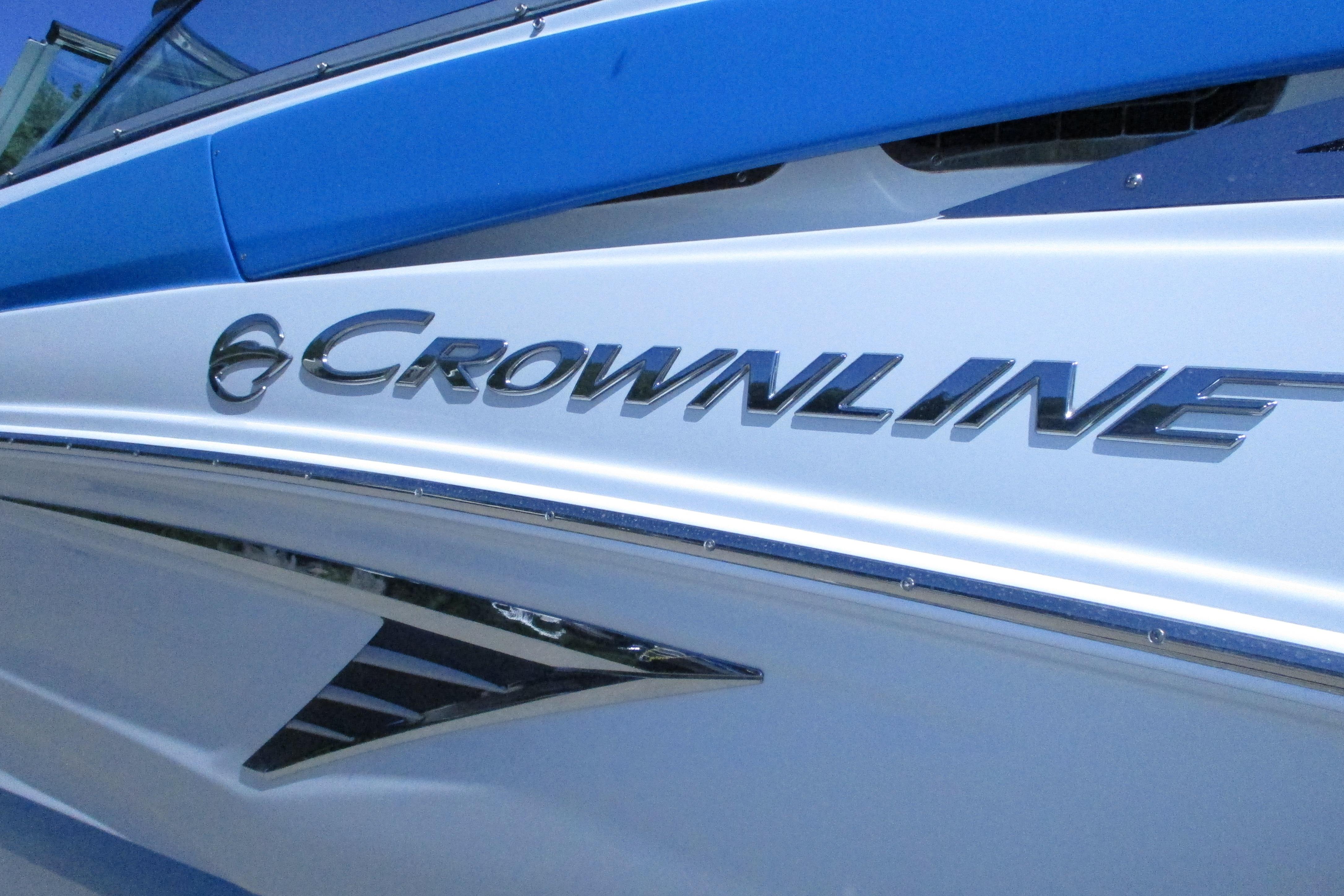 2022 Crownline 260 XSS boat with sleek blue and white design.