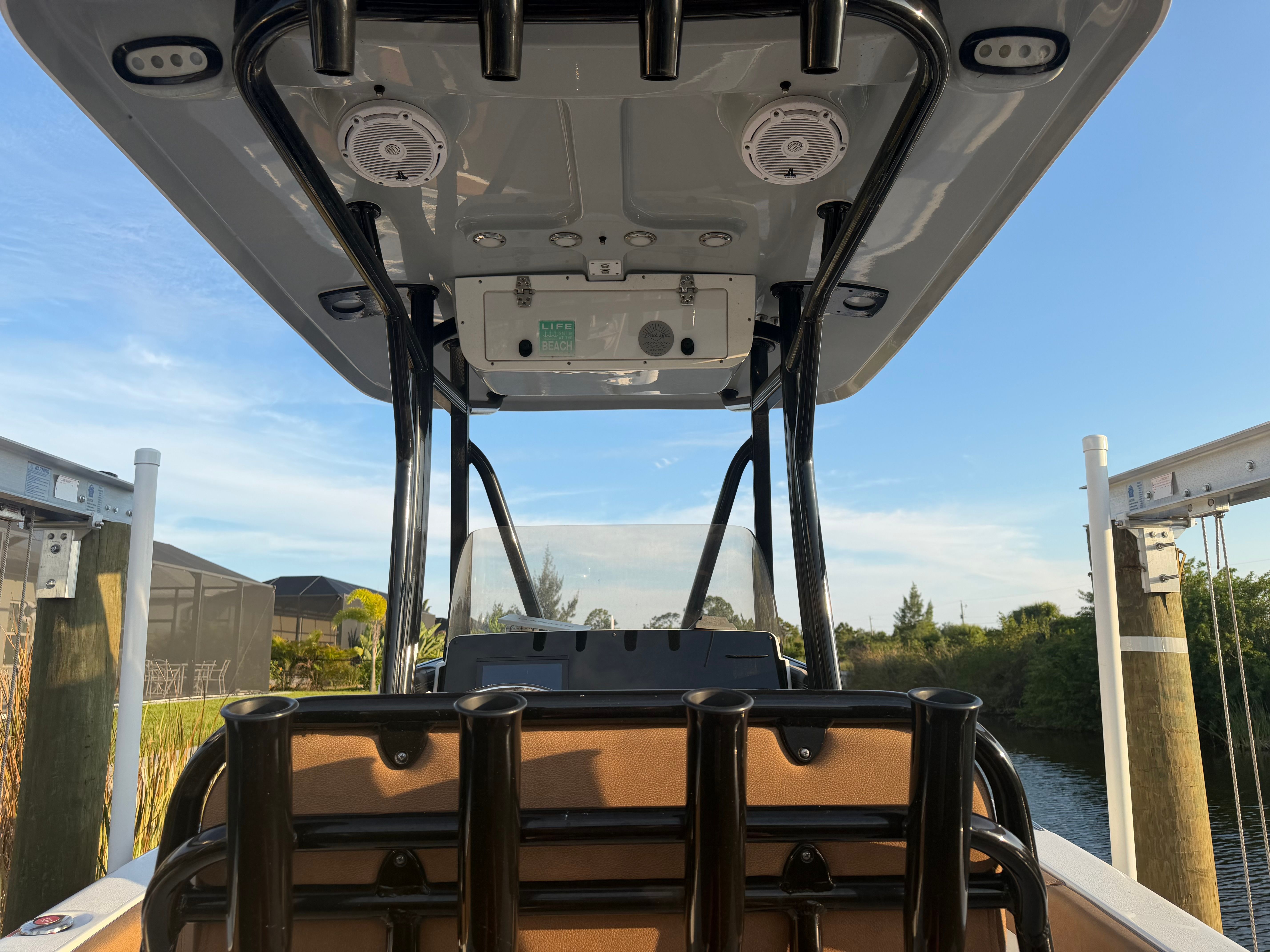 View from the stern of a Sea Hunt Ultra 219 boat docked on a sunny day.
