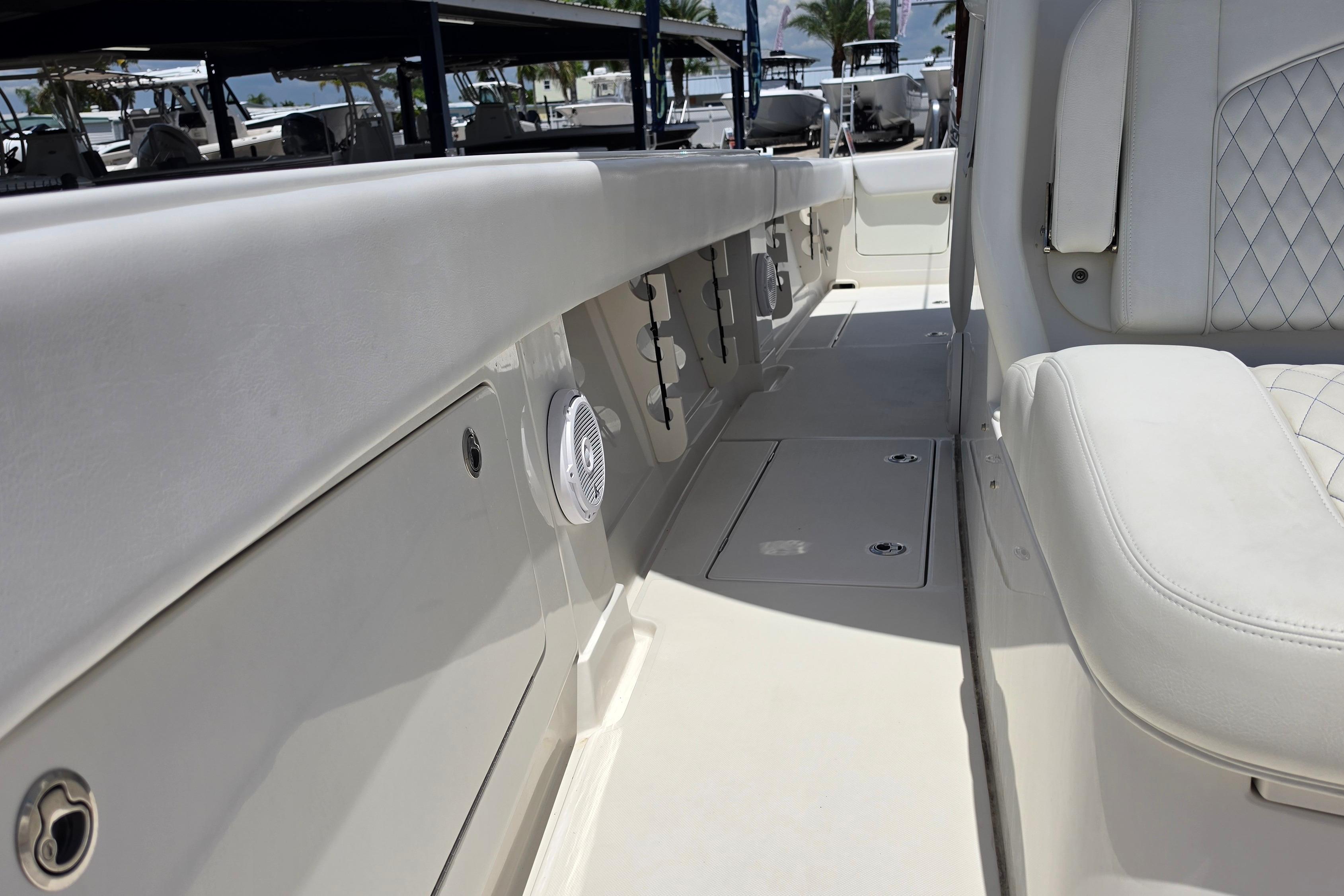 2020 Jupiter 34 HFS boat interior with white seating and storage compartments.