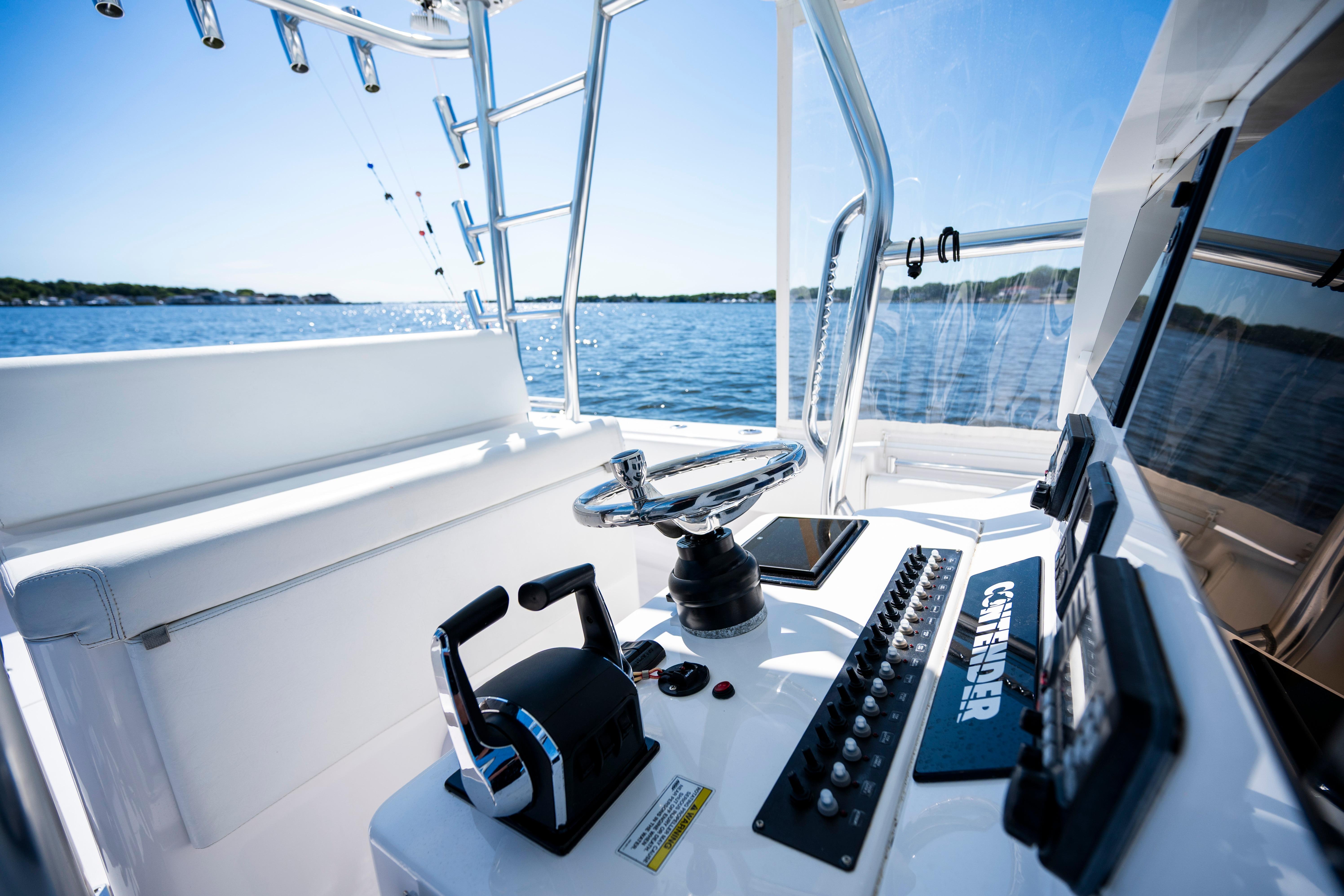 2015 Contender 39 ST boat cockpit with steering wheel and control panel on open water.