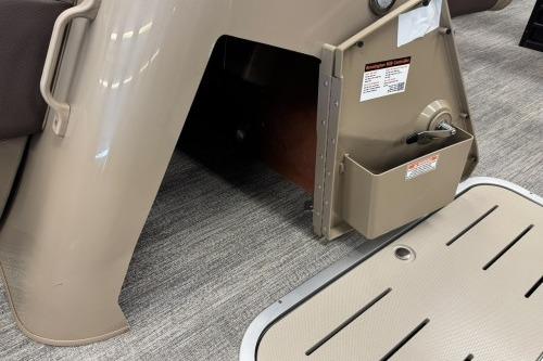 2026 Bennington 22SXSB boat interior detail with storage compartment and beige flooring.