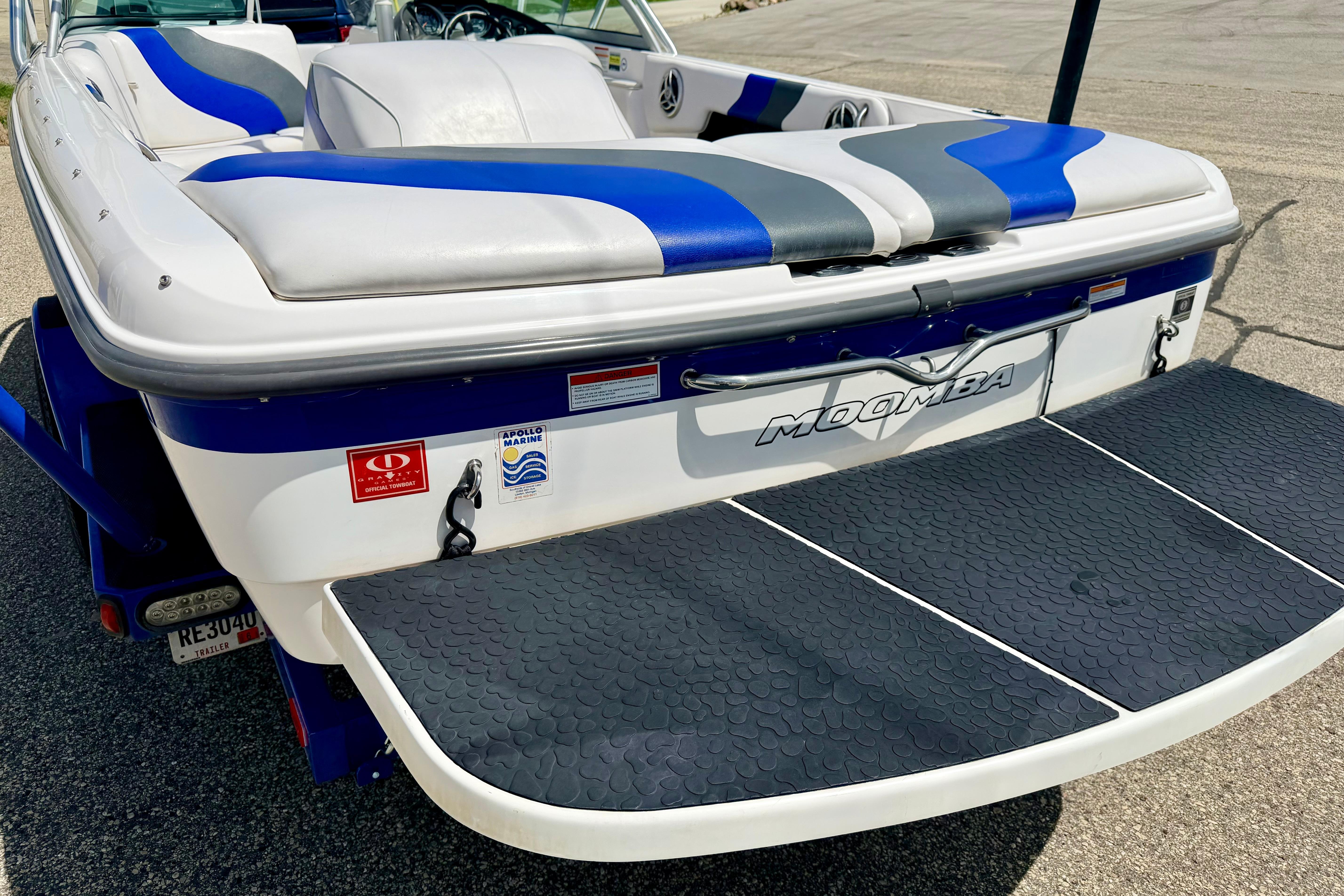 2008 Moomba Outback V boat with blue and gray seating, rear view.