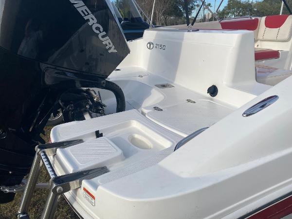 2022 Tahoe 2150 boat with Mercury engine, featuring a swim platform and ladder.