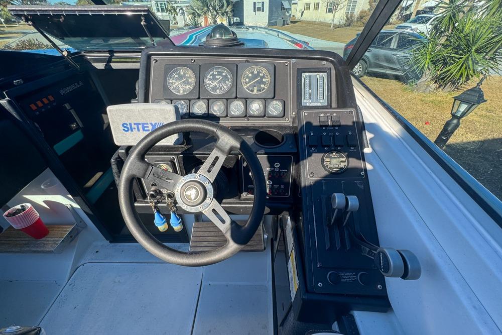 1989 Formula 292 SR-1 boat dashboard with steering wheel and control panel.