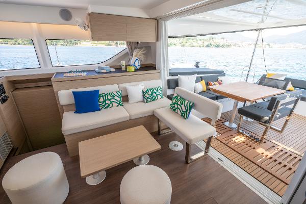 Luxurious interior of 2025 Lagoon 43 yacht with modern seating and scenic water view.