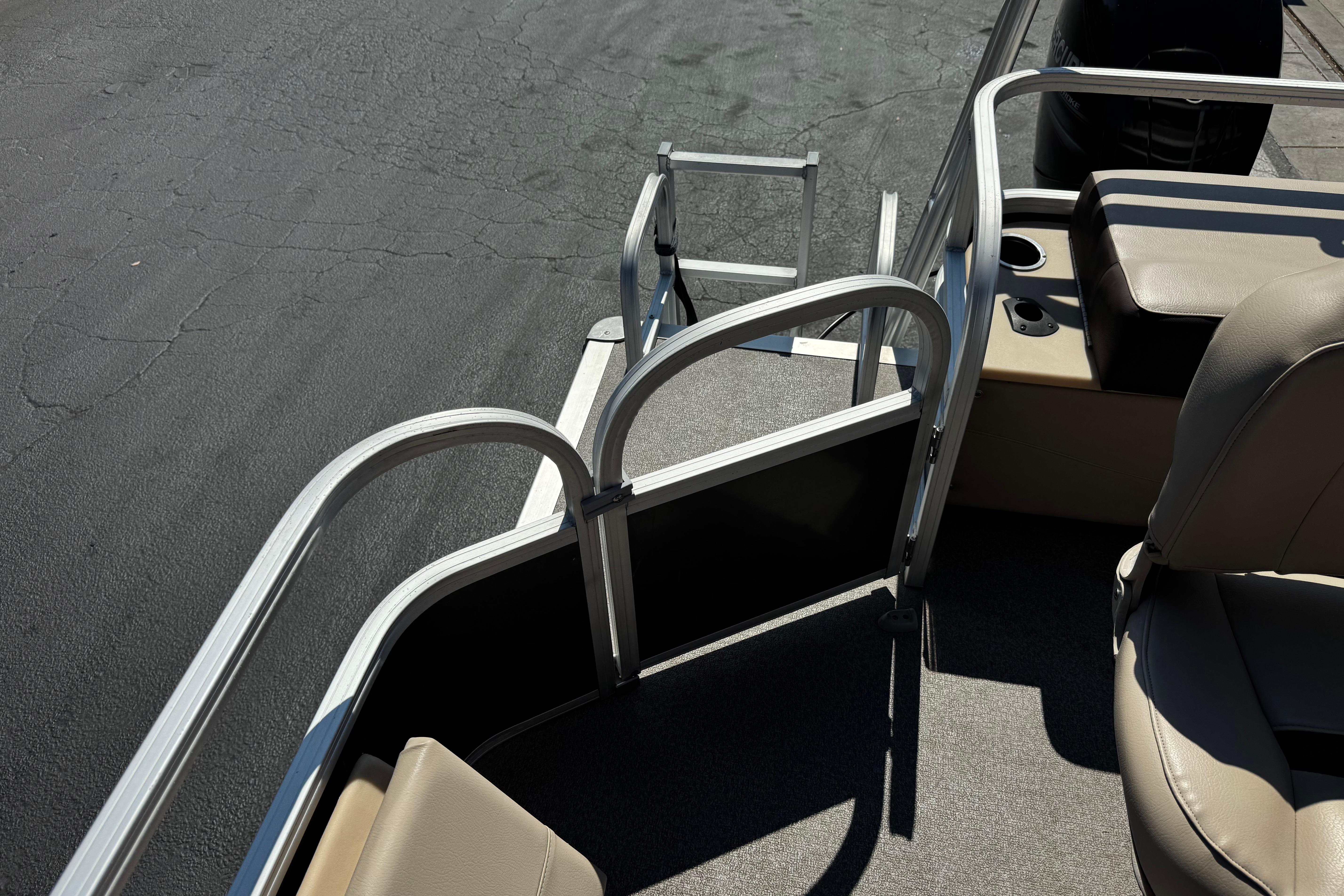 2018 Sun Tracker SportFish 22 DLX boat interior with seating and ladder.