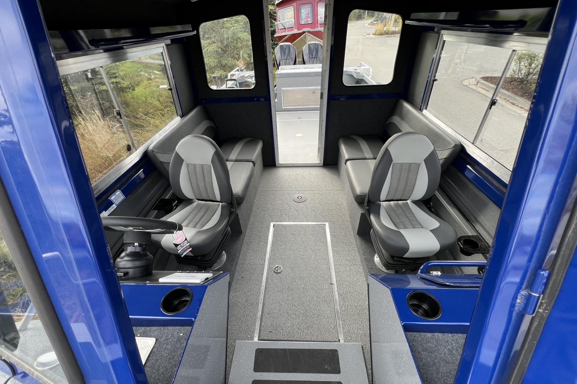 Interior of 2024 Spartan 26 Maximus Pro XL boat with seating and steering console.
