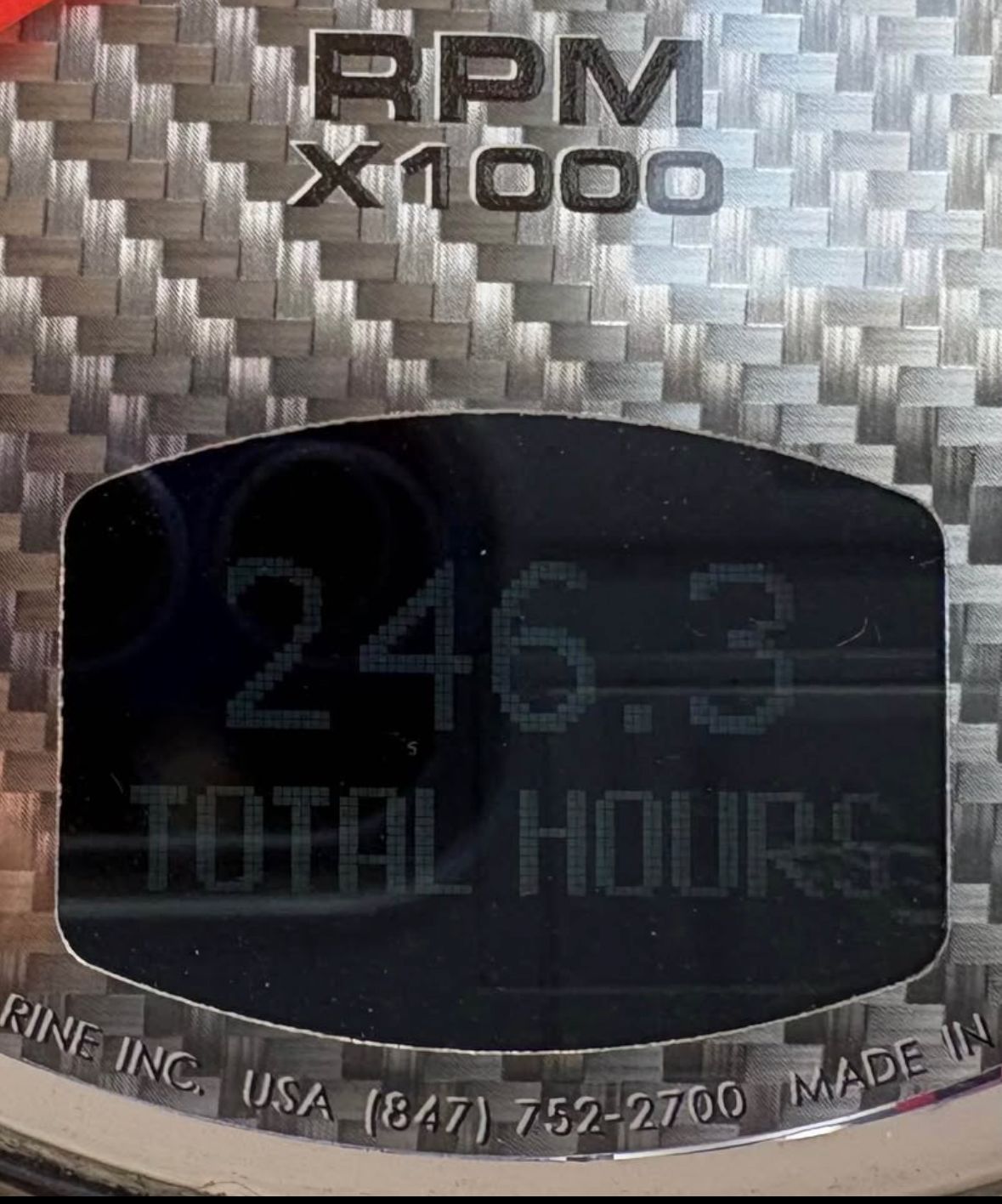 Tachometer displaying 246.3 total hours on carbon fiber background.