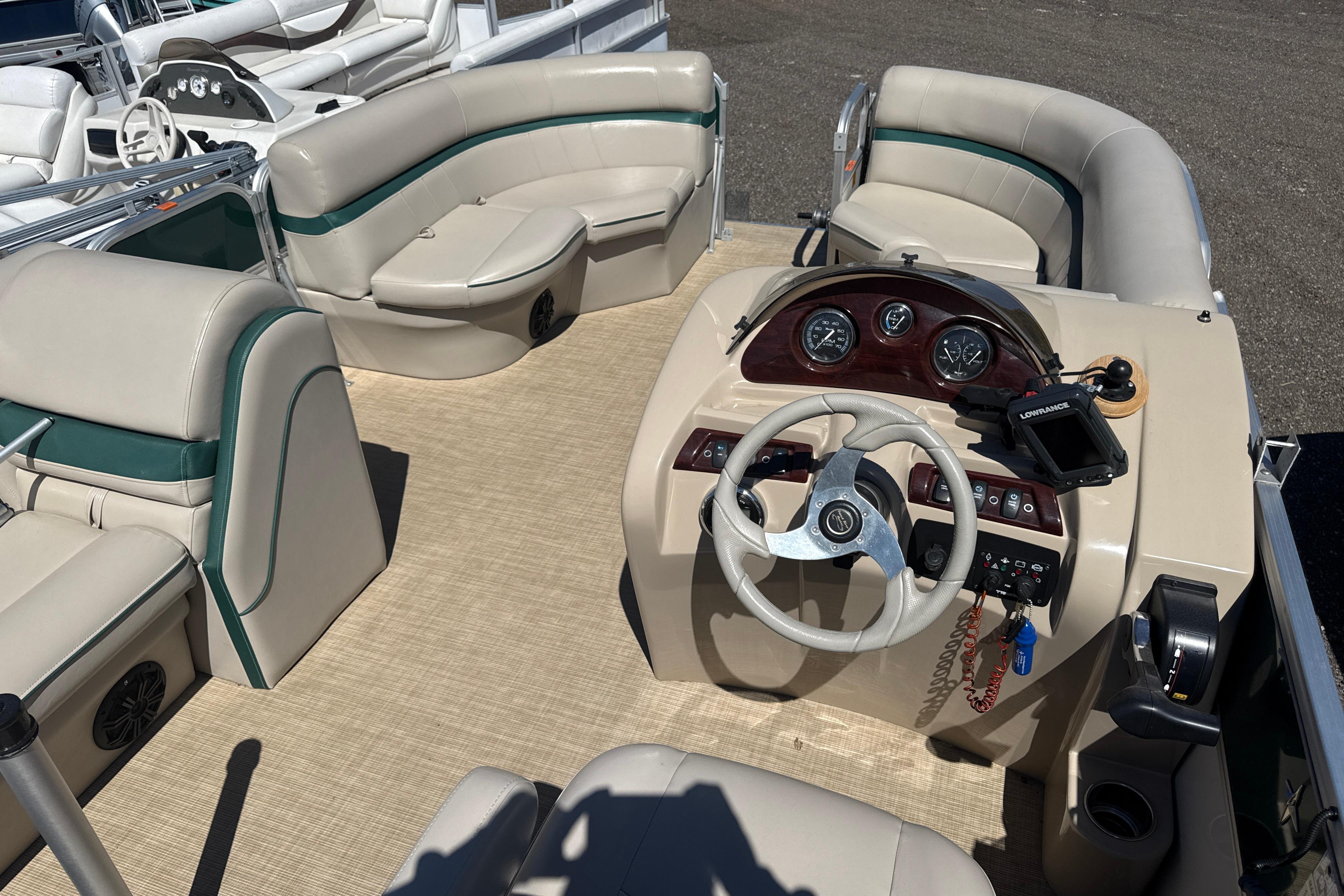 2016 Berkshire 20 pontoon boat interior with beige seating and steering console.