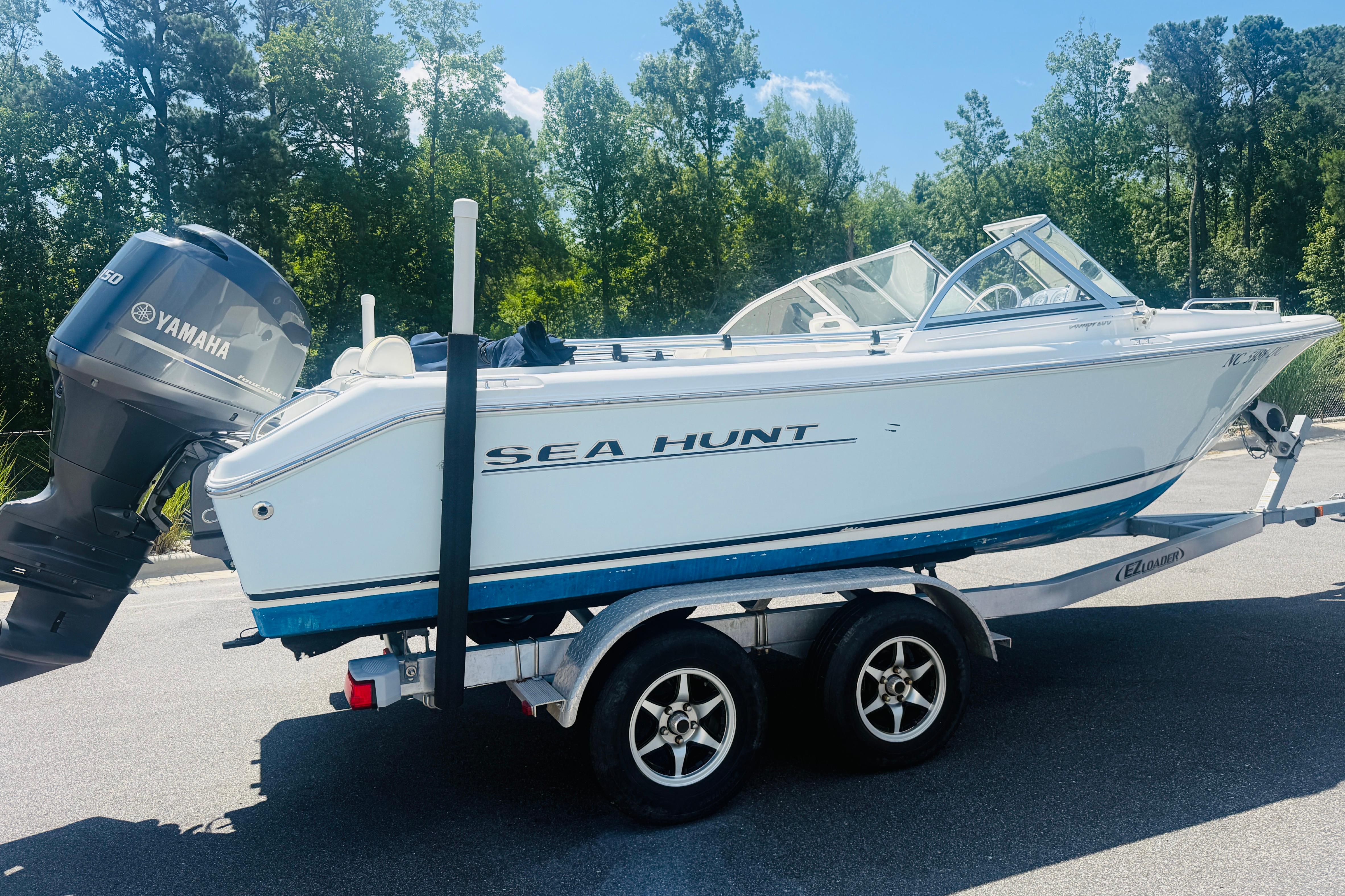2006 Sea Hunt Escape 200 boat on trailer with Yamaha outboard motor.