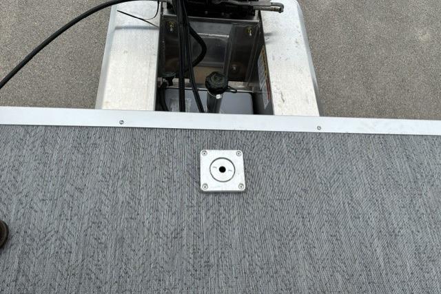 2026 Sun Tracker Fishin' Barge 22 DLX deck with motor compartment.