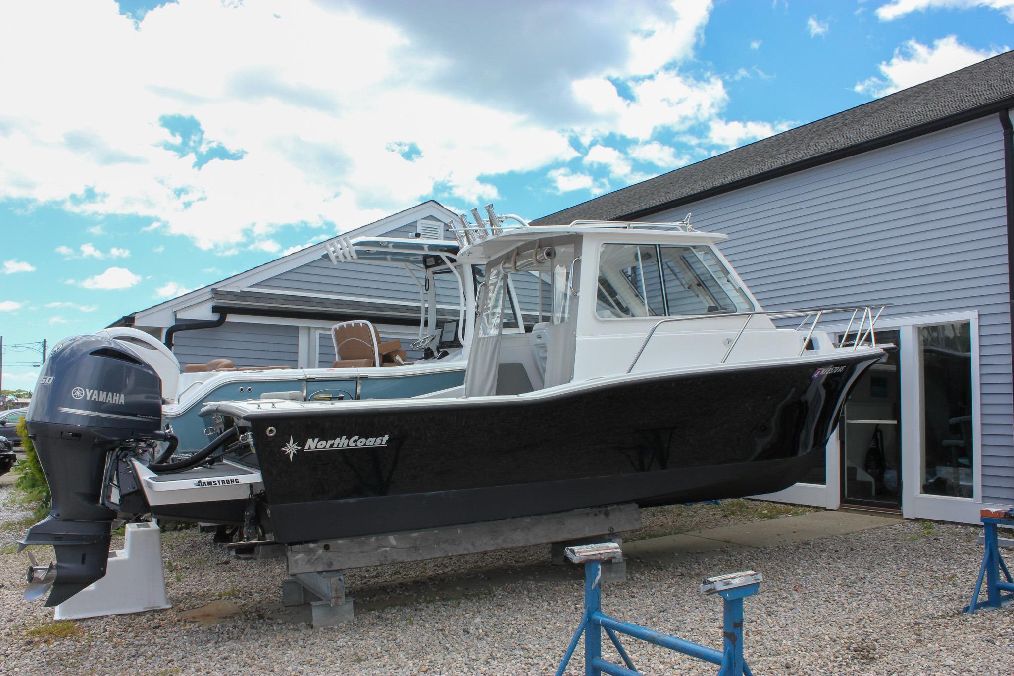 2022 NorthCoast 235 Cabin boat with Yamaha engine on display outdoors.