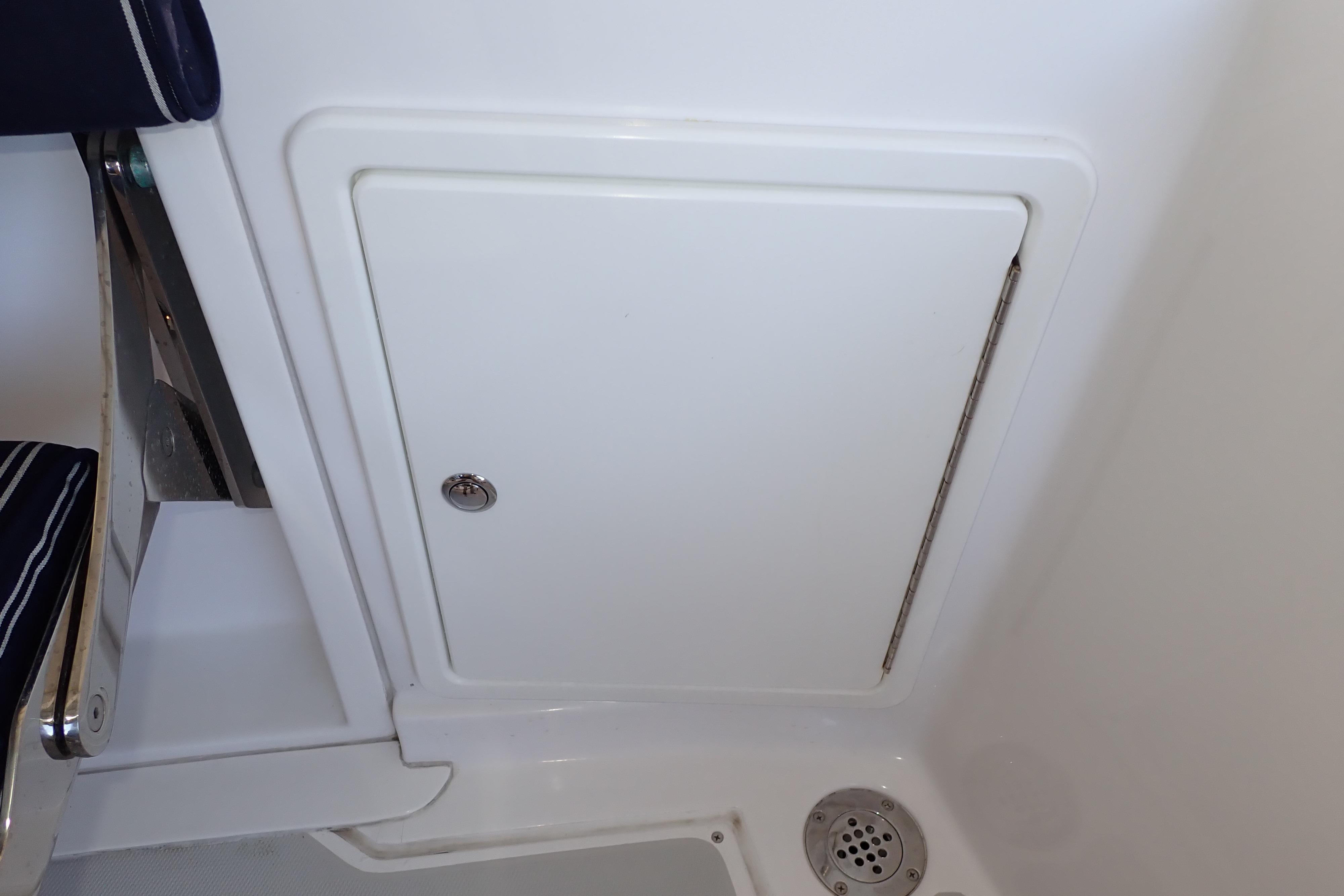2023 True North 34 Outboard Express interior compartment with drain and seating detail.