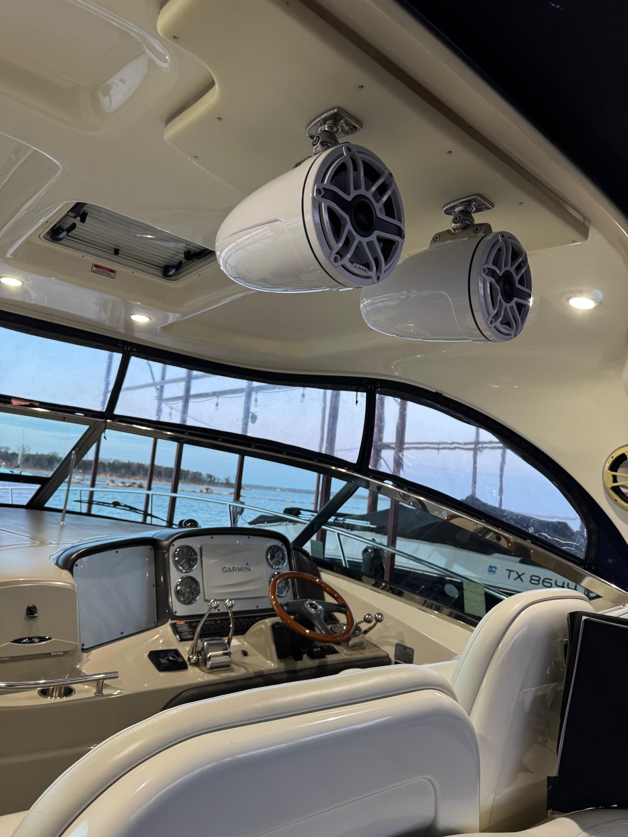 Interior of 2007 Sea Ray 38 Sundancer yacht with speakers and steering wheel.