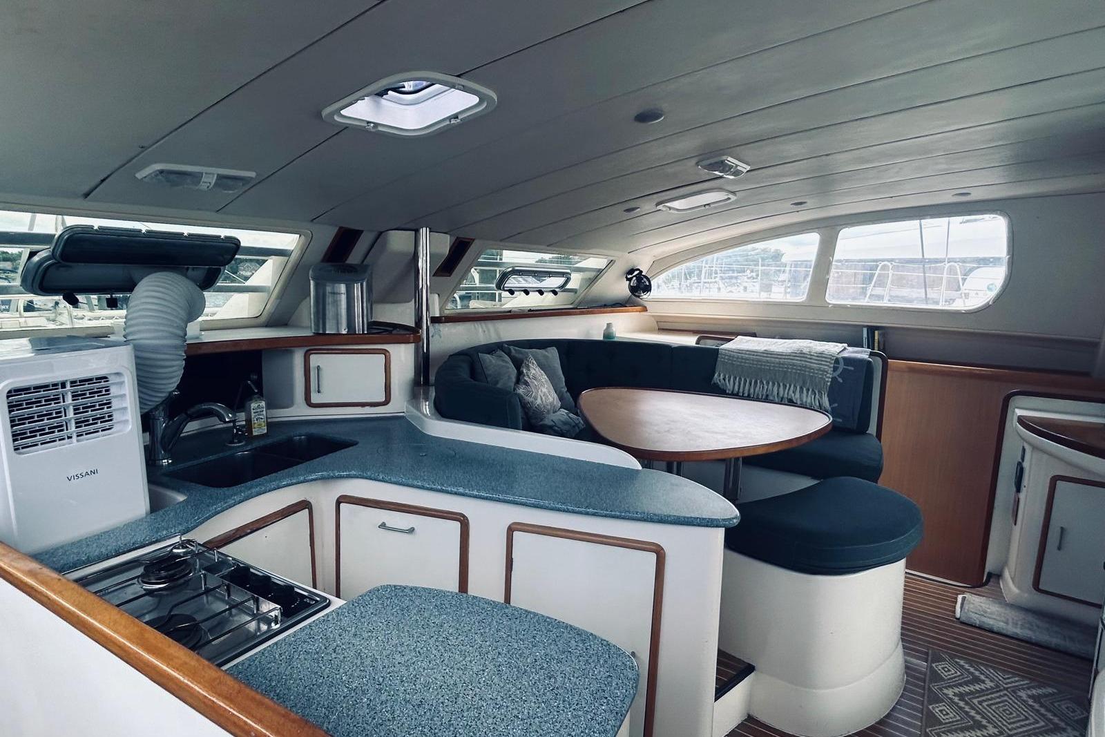 Interior of 2001 Robertson & Caine Leopard yacht with modern kitchen and cozy seating area.