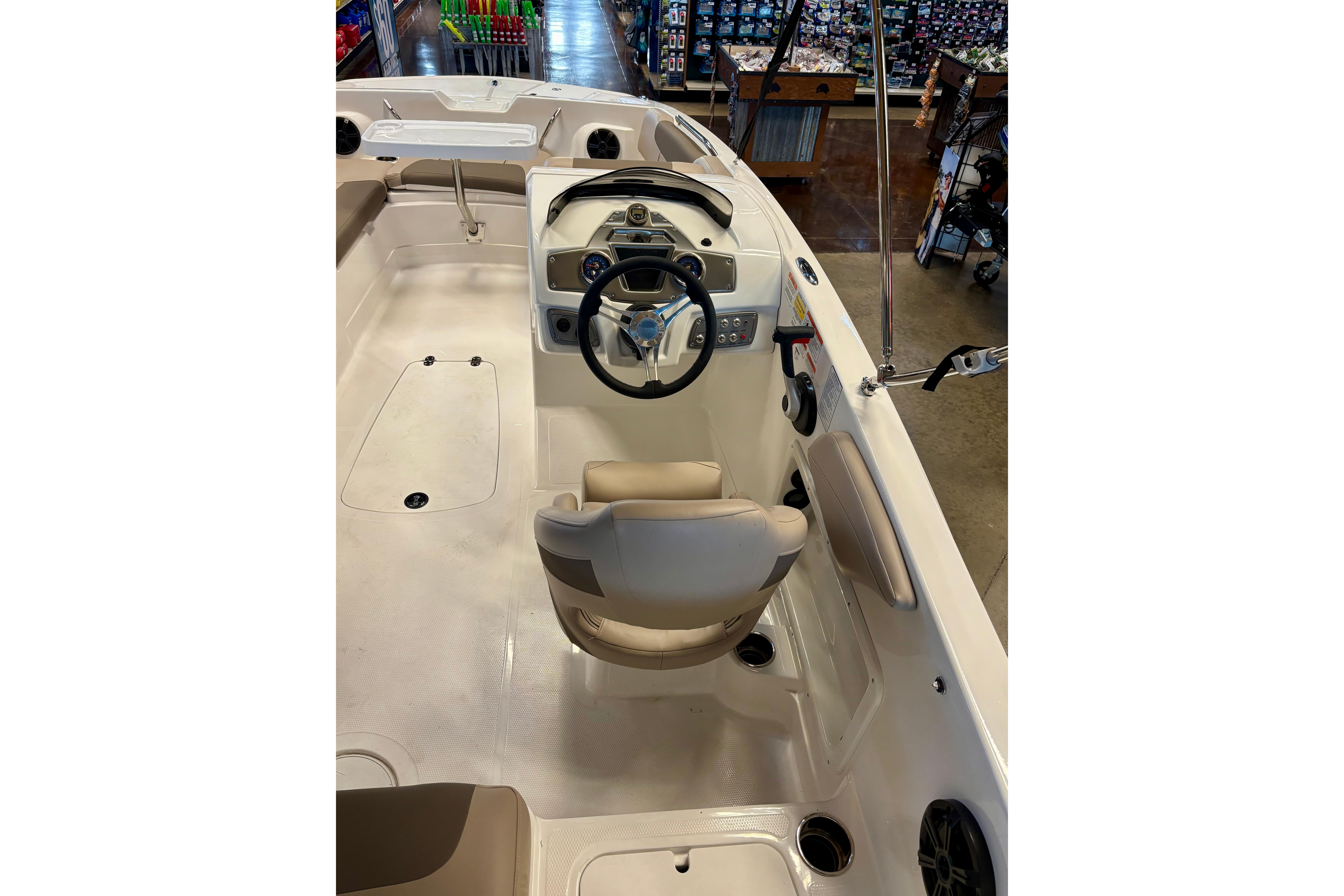 2026 Tahoe 2150 boat interior with steering wheel and seating, showcasing modern design.