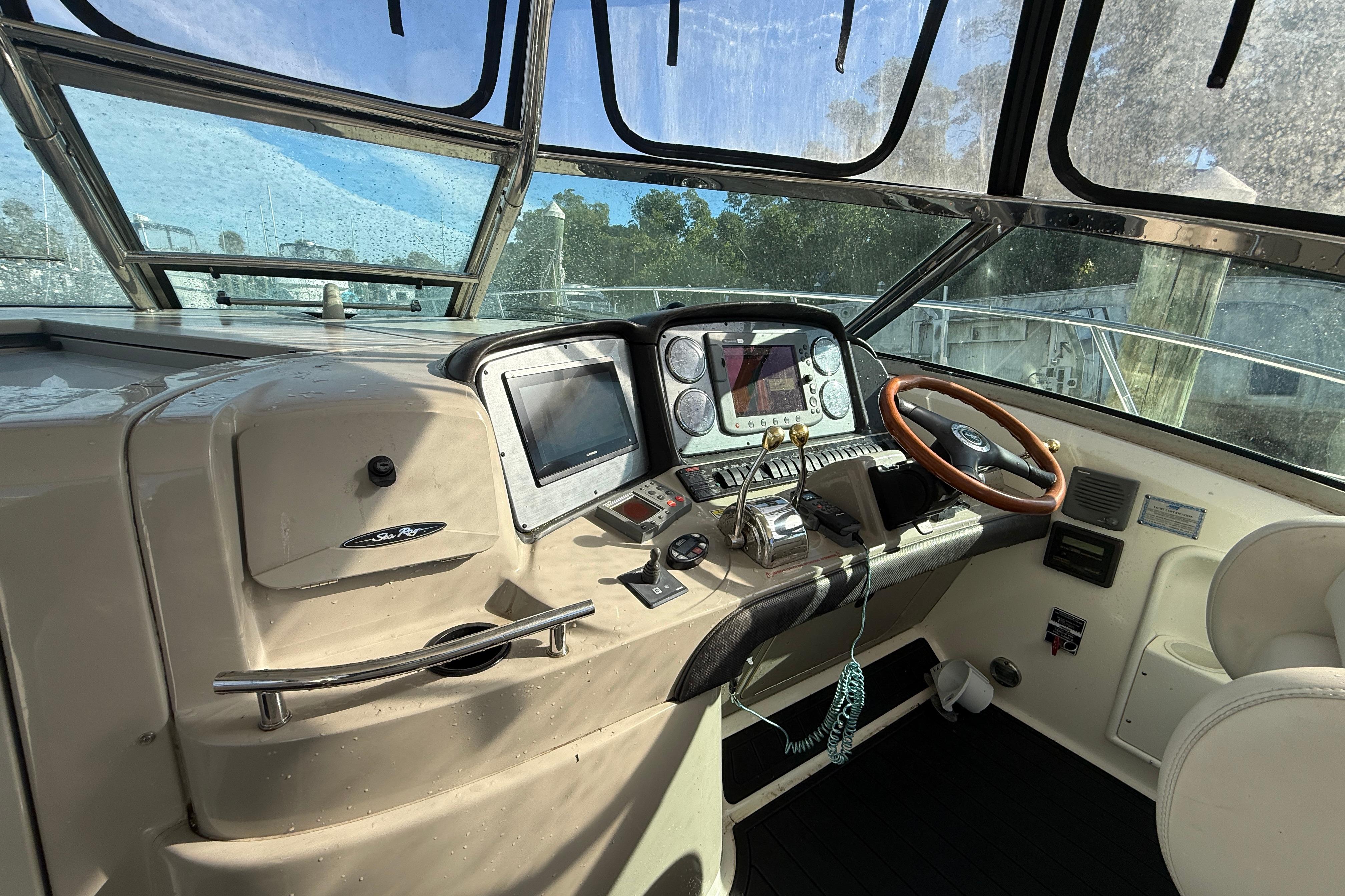 2005 Sea Ray 390 Sundancer helm with navigation controls and steering wheel.