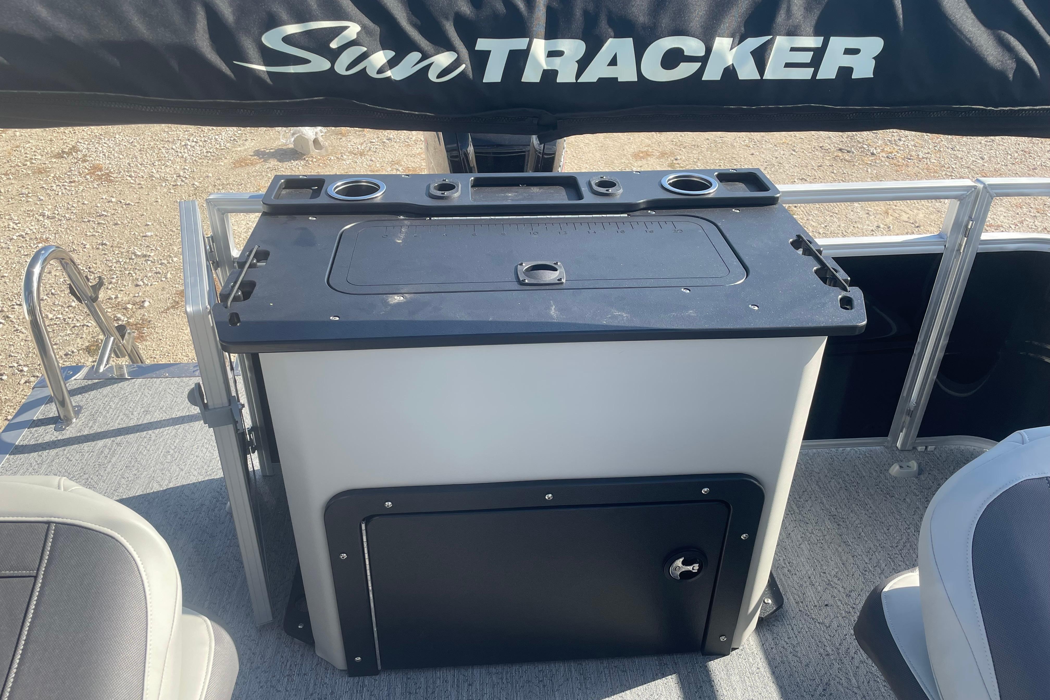 2026 Sun Tracker Fishin' Barge 20 DLX boat console with storage and cup holders.