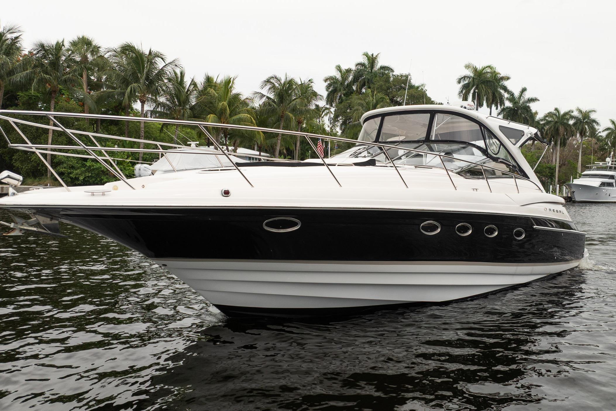2008 Regal Commodore 4460 yacht on water, surrounded by palm trees.