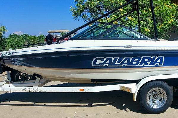 2000 Calabria Sport Comp XTS boat on trailer, side view.
