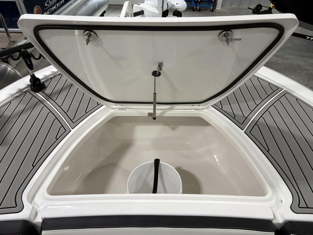 Open storage compartment on 2026 Tidewater 2700 CB boat with gray deck padding.