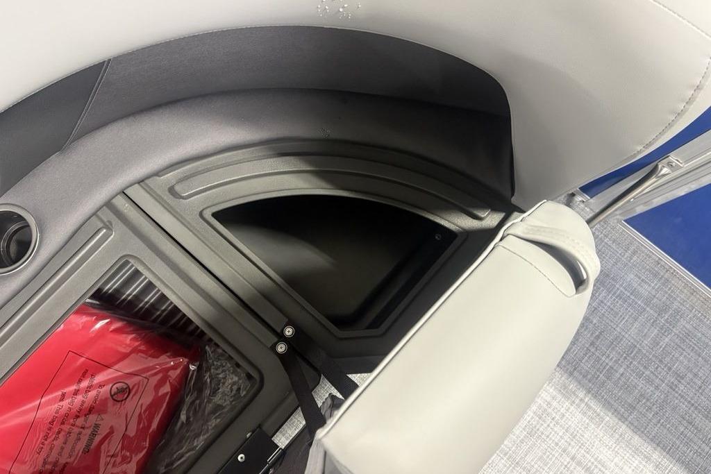 Storage compartment in 2026 Sun Tracker Party Barge 16 DLX with red life jacket.